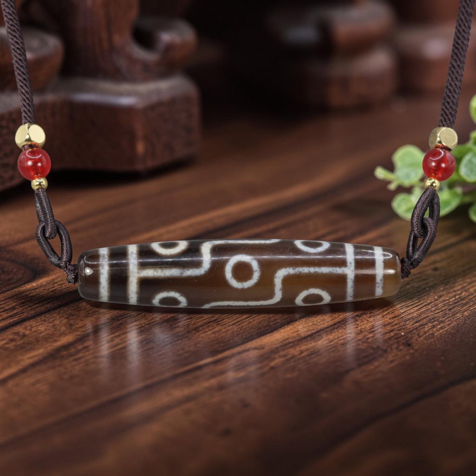 A Chinese Agate Nine Eye Dzi Bead - Tibetan Pendant Necklace, 1YJ: Crafted from translucent warm brown polished natural agate with etched pale white mineral inlay forming elaborate nine-eye symbolic motifs connected by winding geometric lines across the elongated cyl