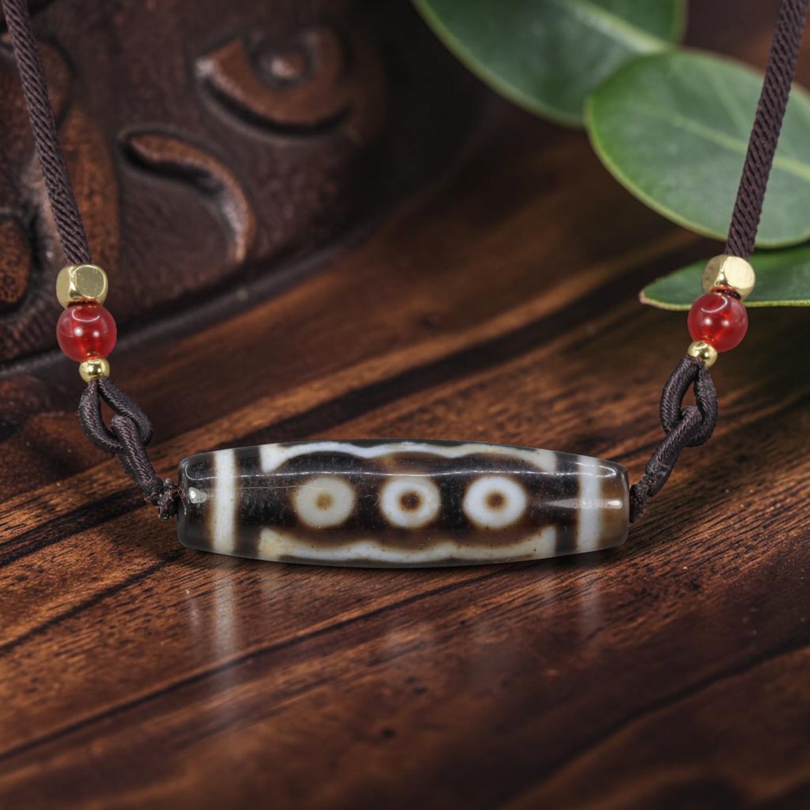 A Chinese Agate Five Eye Dzi Bead - Tibetan Pendant Necklace, 10YJ: Crafted from polished natural agate with etched pale white mineral inlay forming symmetrical five-eye symbolic motifs framed by border banding across the cylindrical bead form. The five eye totem hold