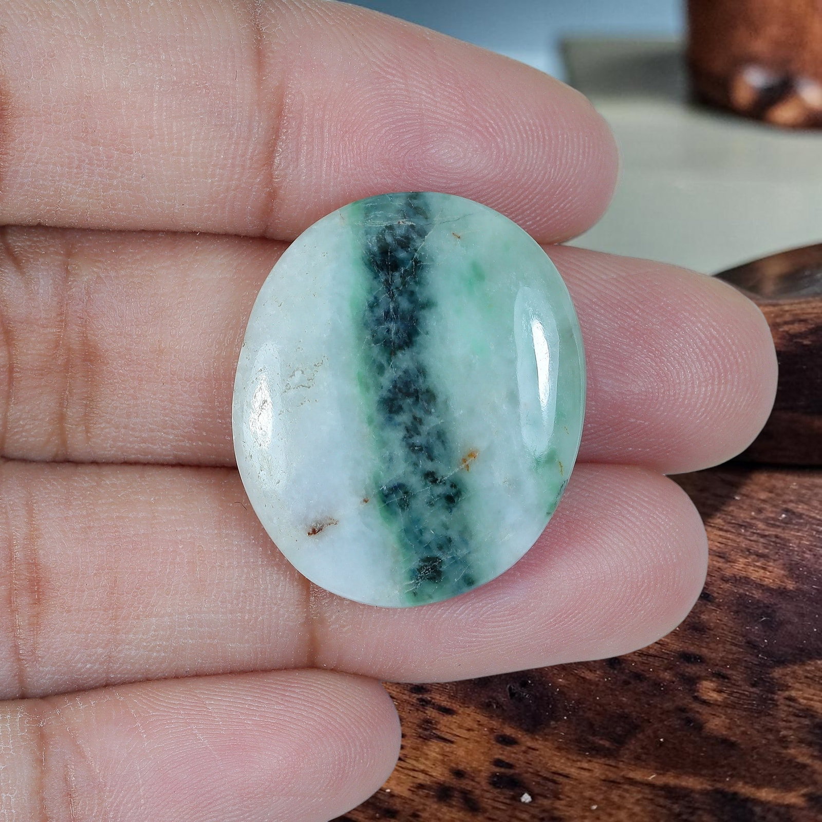 25.91ct Natural Burmese Type A Central Dark Green Band Oval Jadeite Jade Cabochon, 79AR: Crafted from fully untreated natural Burmese Type A jadeite jade, this balanced medium oval cabochon features a moderately plump domed top paired with flat base, well-suited for eye-catching cocktail 