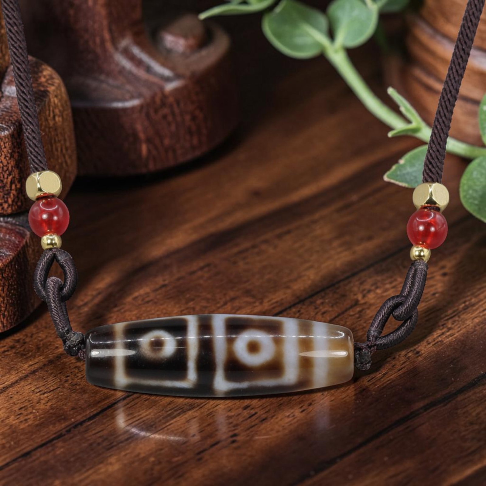 A Chinese Agate Four Eye Dzi Bead - Tibetan Pendant Necklace, 6YJ: Crafted from polished natural agate with etched white mineral inlay forming symmetrical four-eye symbolic motifs divided by vertical banding across the cylindrical bead form. The four eye totem is a c