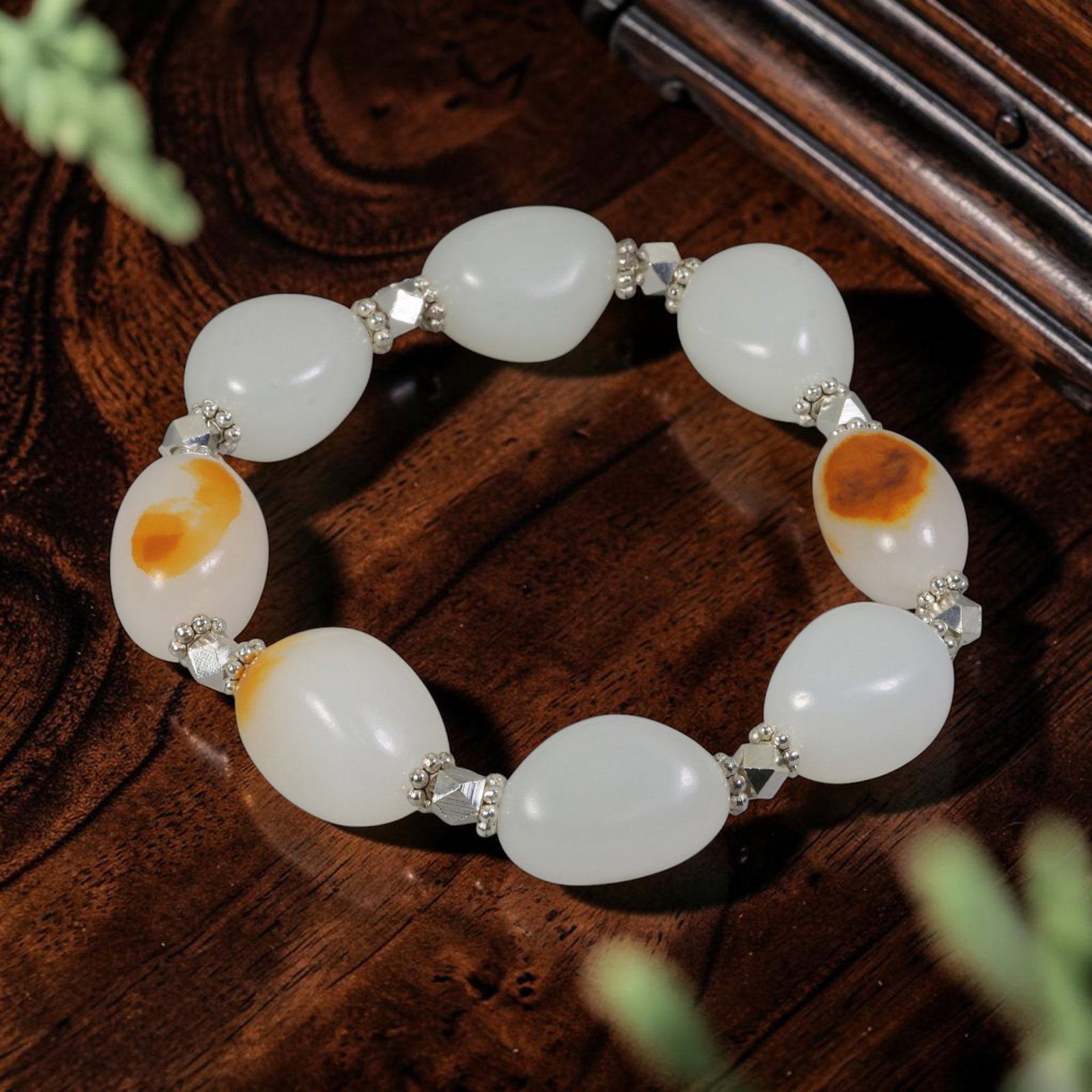 Chinese Hetian Nephrite White Seed Pebble Jade Beaded Bracelet, 84AR: This handcrafted bracelet is constructed from natural uncarved Chinese Hetian nephrite white seed pebble jade. Each smooth river-polished pebble features organic teardrop oval silhouettes with a cream