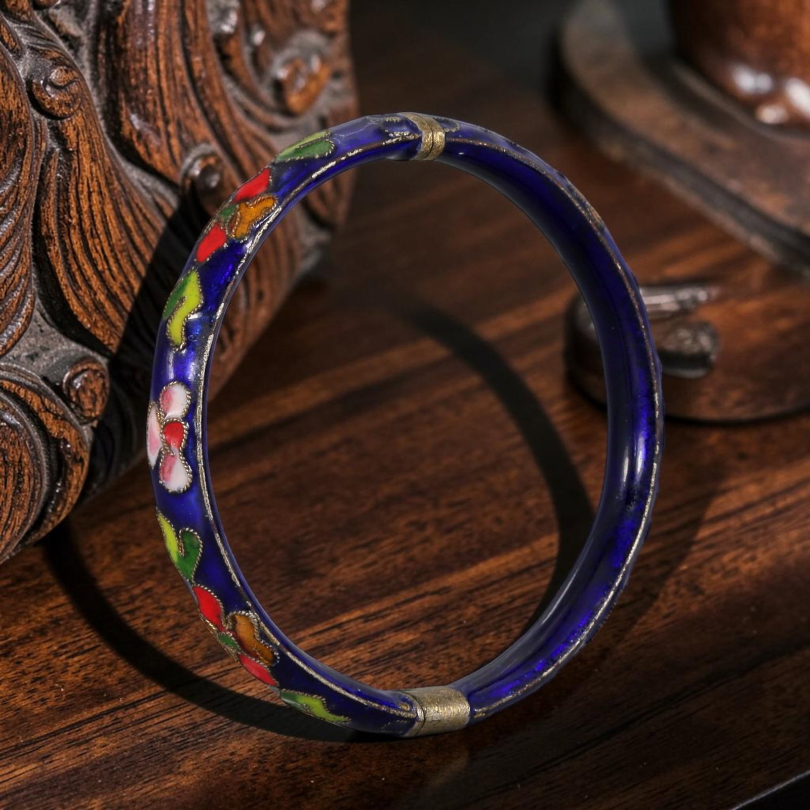 Vintage Chinese Cloisonne Bangle - Floral Enamel Bracelet, 7AS: Crafted from brass base metal with traditional Chinese cloisonne wire work, this circular bangle features deep cobalt blue enamel ground inlaid with polychrome floral motifs of pink, red, green and ye