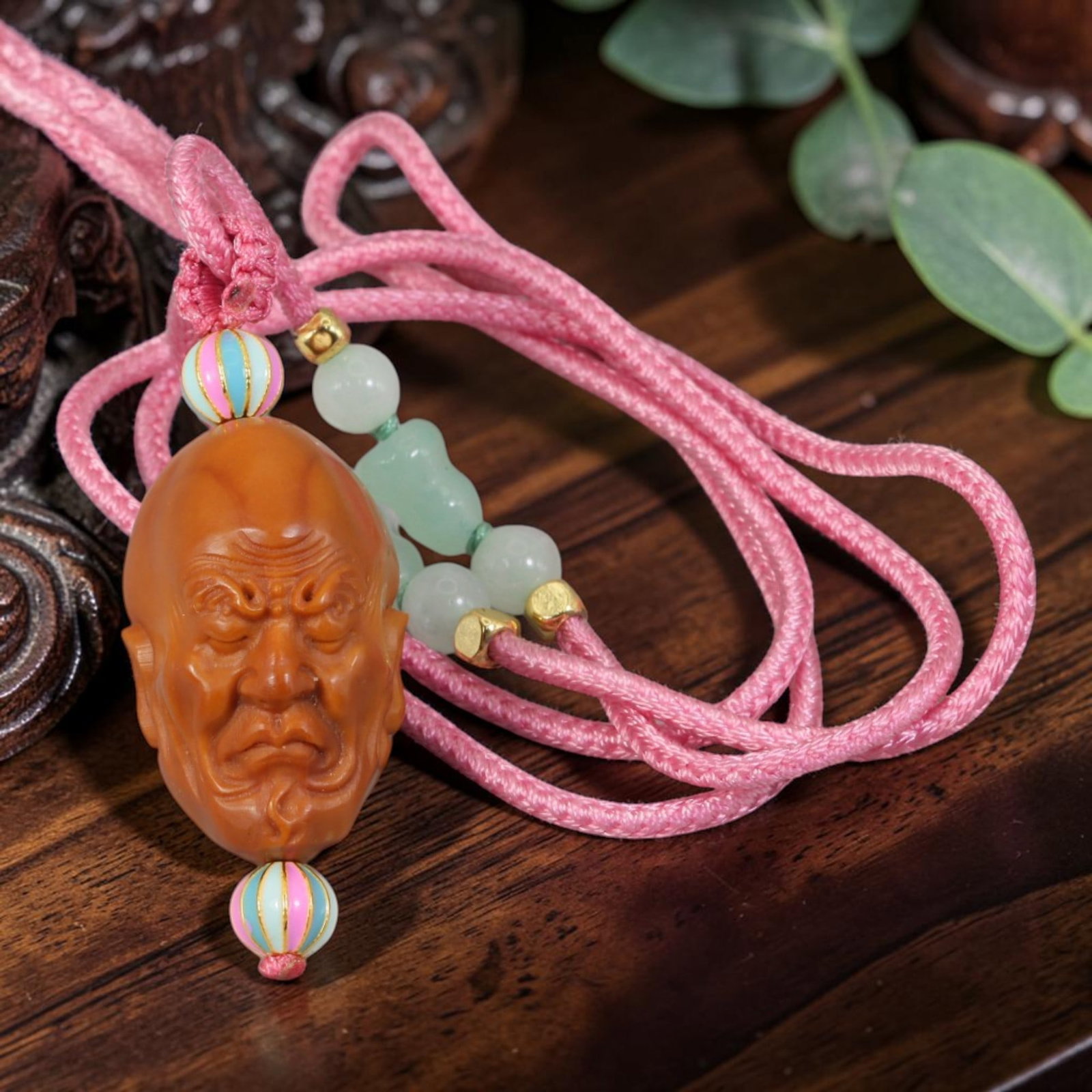 Chinese Olive Nut Pendant - Furrowed Arhat Luohan Head Carving, 9AT: Crafted from solid natural olive nut kernel, this wearable pendant features precise hand carving of a furrowed-brow Arhat (Luohan) head with solemn closed-eye facial features, a classic motif within t