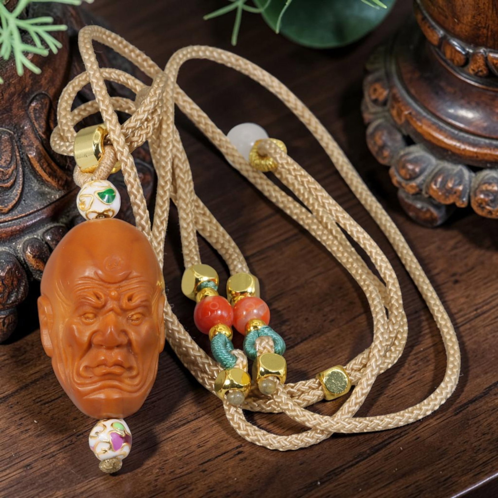 Chinese Olive Nut Pendant - Stern Wrinkled Arhat Luohan Carving, 10AT: Crafted from solid natural olive nut kernel, this wearable pendant features detailed hand-carved rendering of a stern wrinkled Arhat (Luohan) head with deeply lined facial textures, a prominent motif 