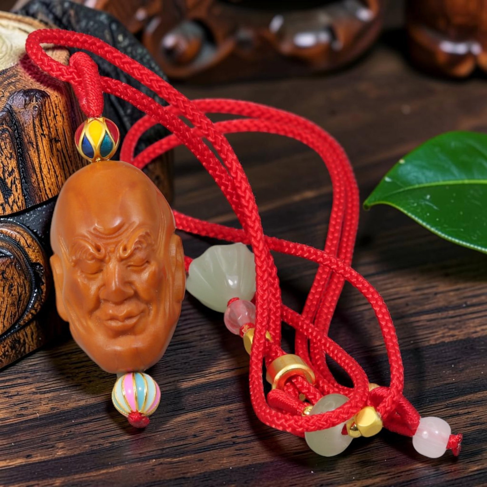 Chinese Olive Nut Pendant - Gentle Smiling Arhat Luohan Head Carving, 19YJ: Carved from solid natural olive nut kernel, this wearable pendant features delicate hand carving of a soft smiling Arhat (Luohan) head with half-lidded peaceful eyes, a mild devotional motif from trad