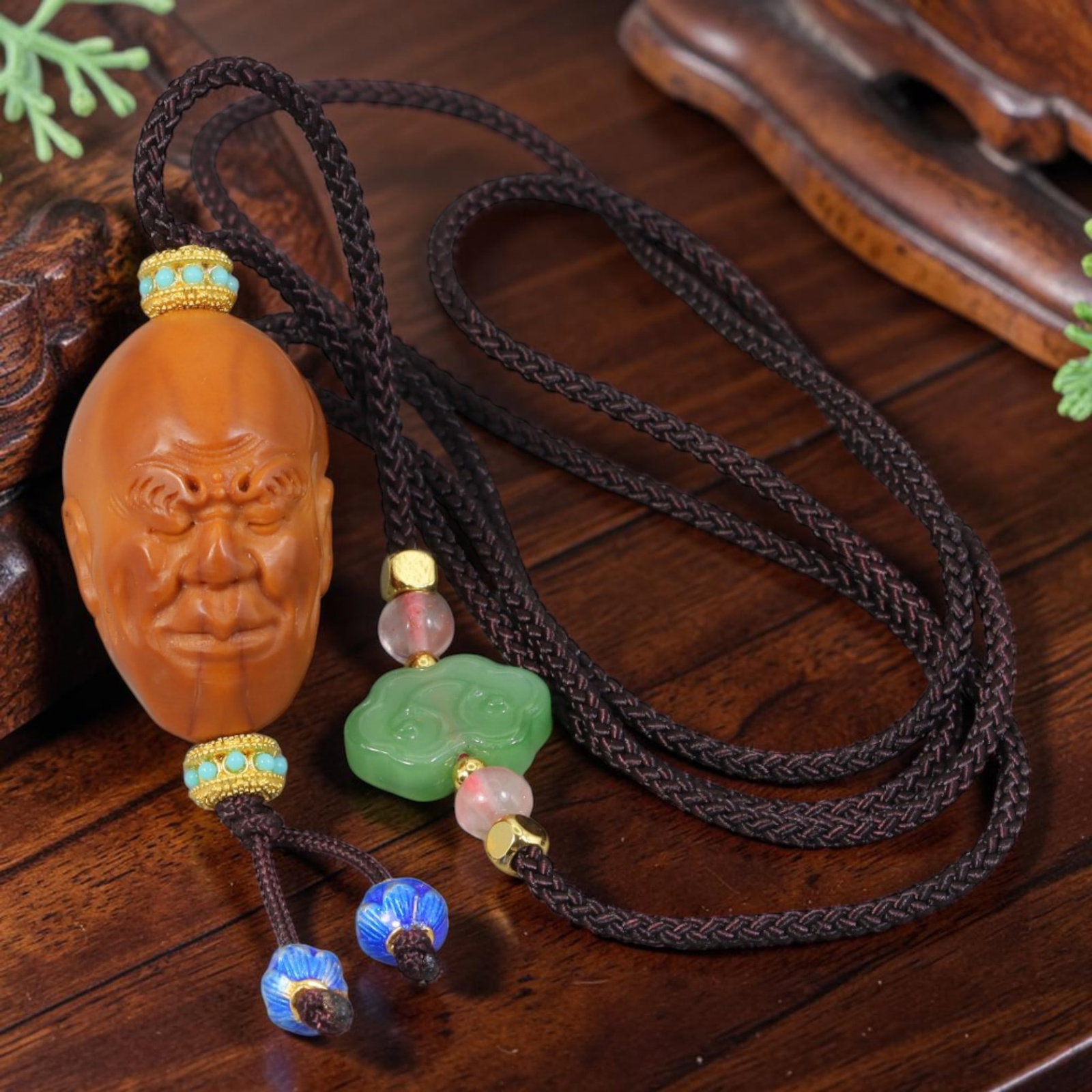 Chinese Olive Nut Pendant - Serene Wrinkled Arhat Luohan Carving, 15AT: Carved from solid natural olive nut kernel, this wearable pendant features fine hand carving of a serene wrinkled Arhat (Luohan) head with soft closed-eye facial detailing, a classic motif of traditio
