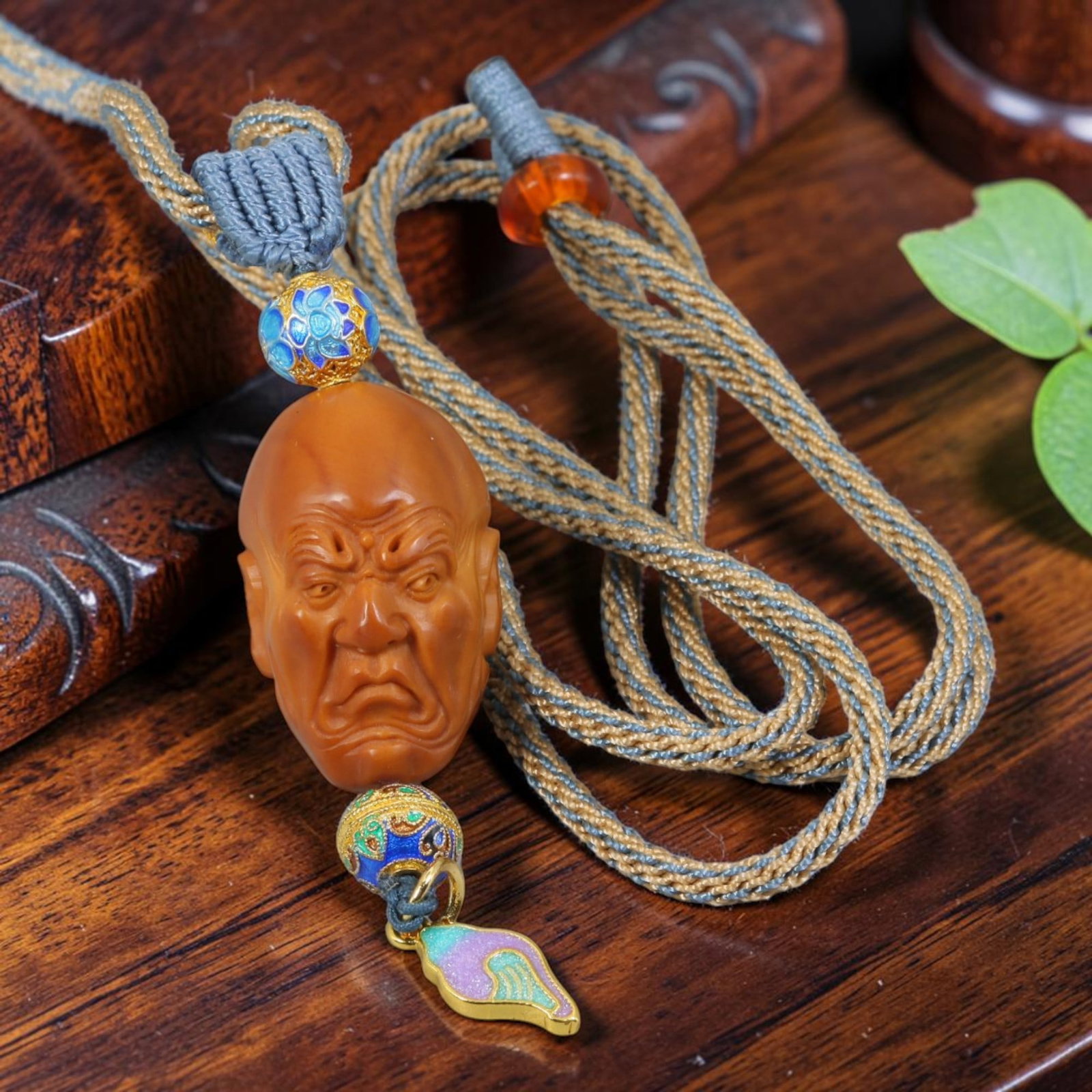 Chinese Olive Nut Pendant - Stern Arhat Luohan Head Carving, 14AT: Carved from solid natural olive nut kernel, this wearable pendant presents sharply detailed handwork depicting a stern-faced Arhat (Luohan) head with furrowed brows and intense facial expression, repr