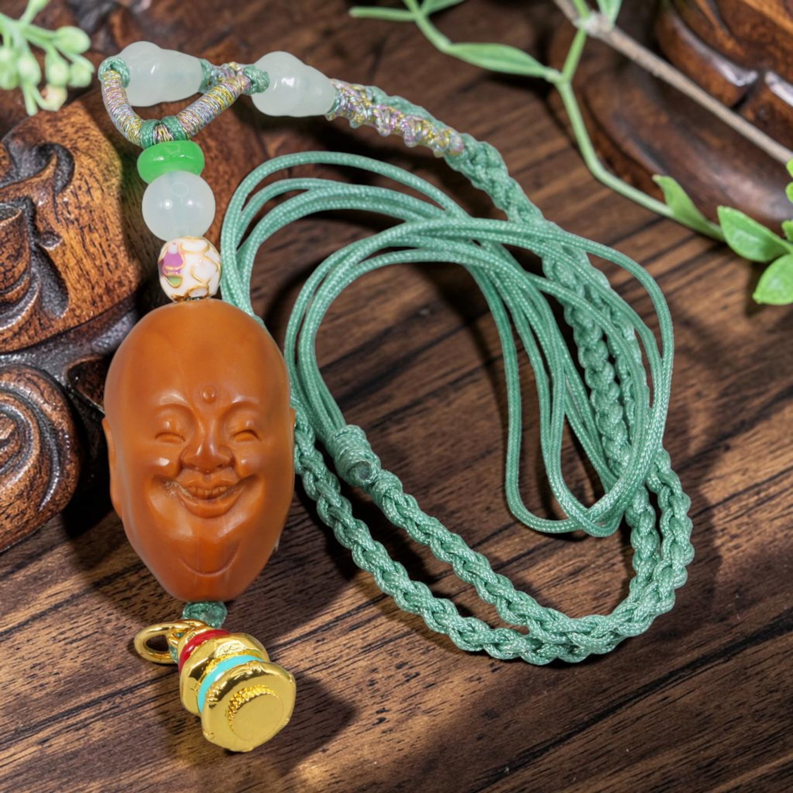 Chinese Olive Nut Pendant - Smiling Arhat Luohan Head Carving, 17AT: Carved from solid natural olive nut kernel, this wearable pendant features refined hand carving of a joyful smiling Arhat (Luohan) head with soft, gentle facial contours, a gentle motif within traditi