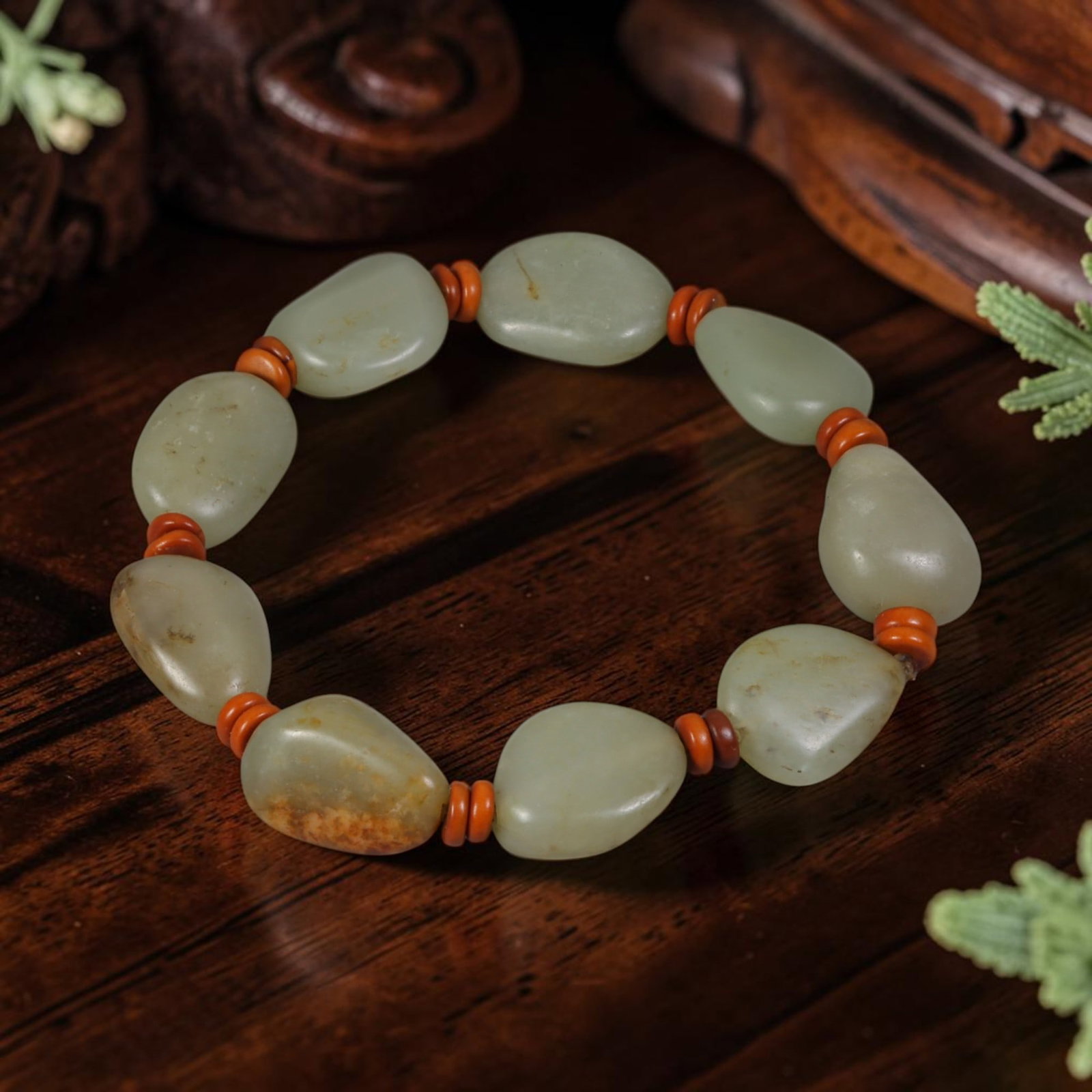 Chinese Hetian Nephrite Seed Pebble Bracelet - Pale Celadon River Jade Ornament, 91AR: This bracelet is strung from natural unworked Hetian nephrite river seed pebbles, each bearing organic teardrop and oval river-worn silhouettes with a soft pale celadon base hue, accented by scattered
