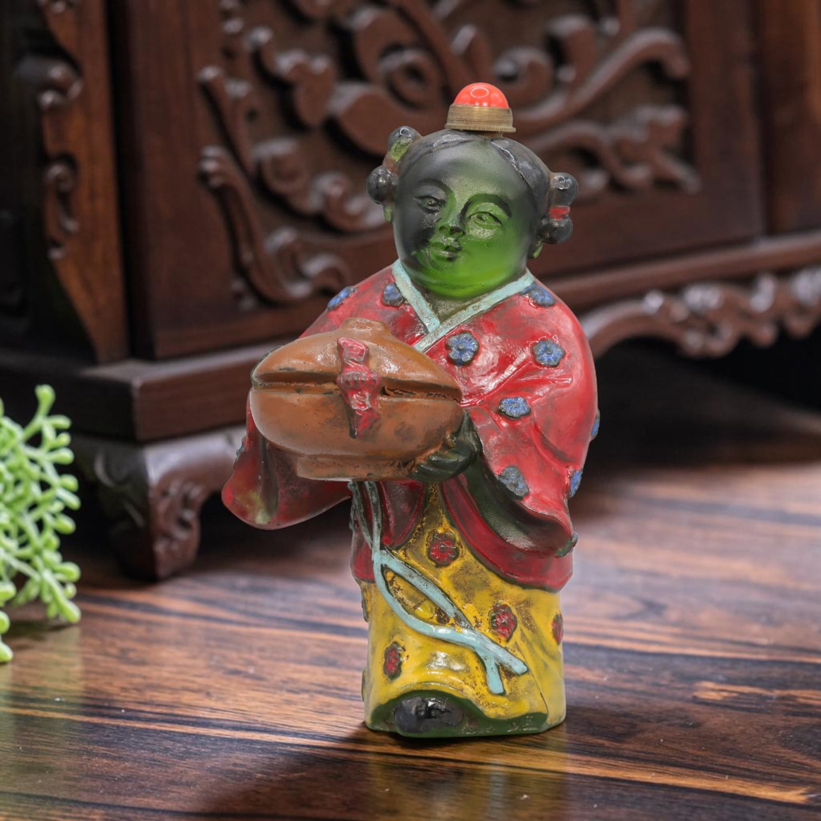 Vintage Chinese Painted Liuli Snuff Bottle - Girl Figurine, 65YF: Crafted from translucent green liuli glass, this vintage Chinese snuff bottle is modelled as a standing girl figure holding a covered vessel. The glass body is hand-painted in vibrant colours: the fig