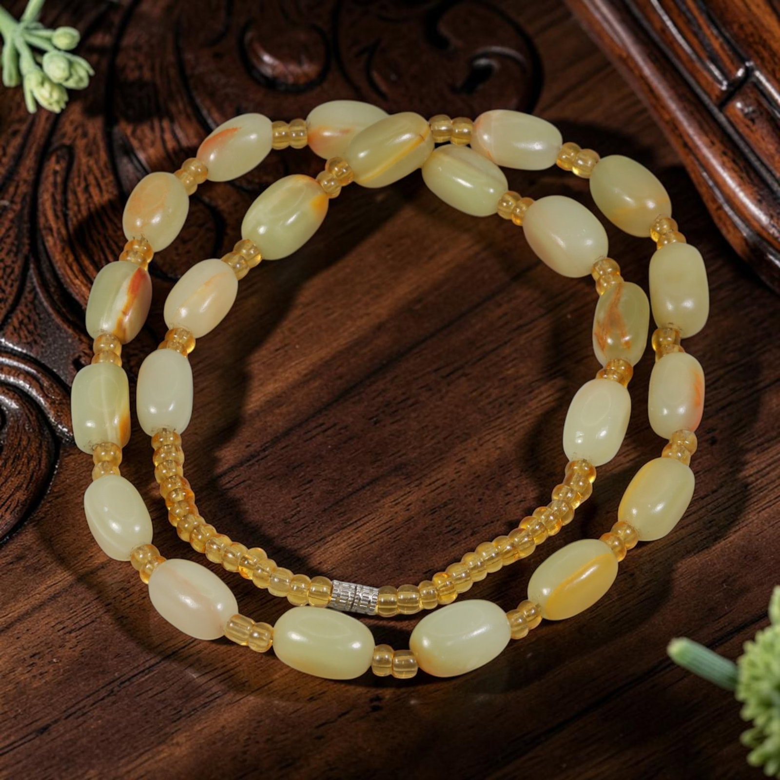 Natural Xinjiang Hetian Jade Pebble Beaded Necklace, 3YM: This elegant necklace features smooth, natural Hetian jade pebbles, strung with small translucent yellow spacer beads and finished with a silver-toned clasp. The jade pebbles display soft pale yellow 