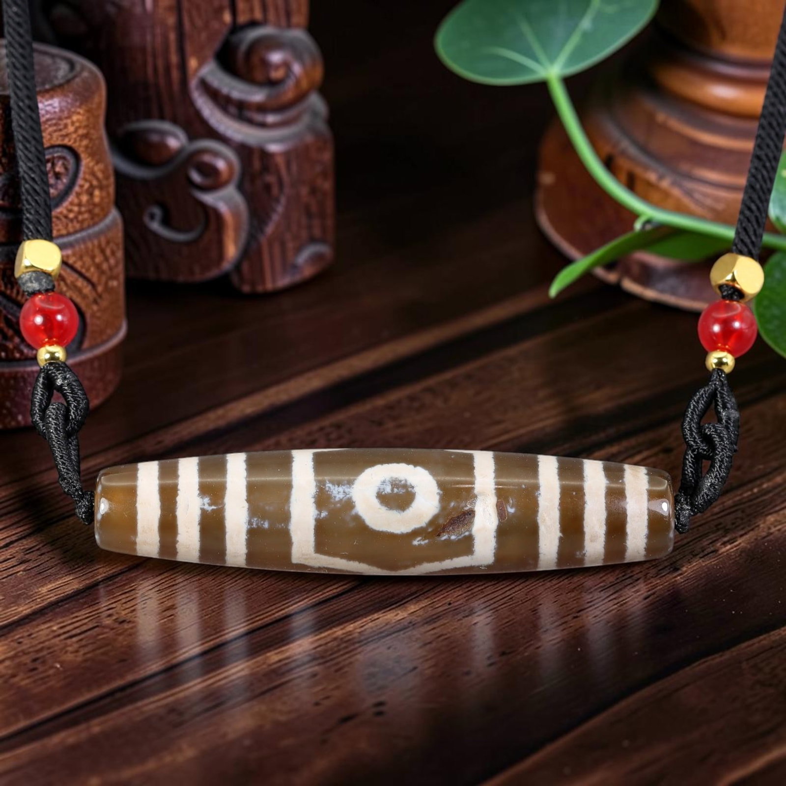 A Chinese Agate Three Eye Dzi Bead - Tibetan Pendant Necklace, 93AS: Crafted from translucent warm taupe natural agate with etched creamy white mineral inlay forming distinct three-eye symbolic motif enclosed by symmetrical vertical banding across the elongated cylindr