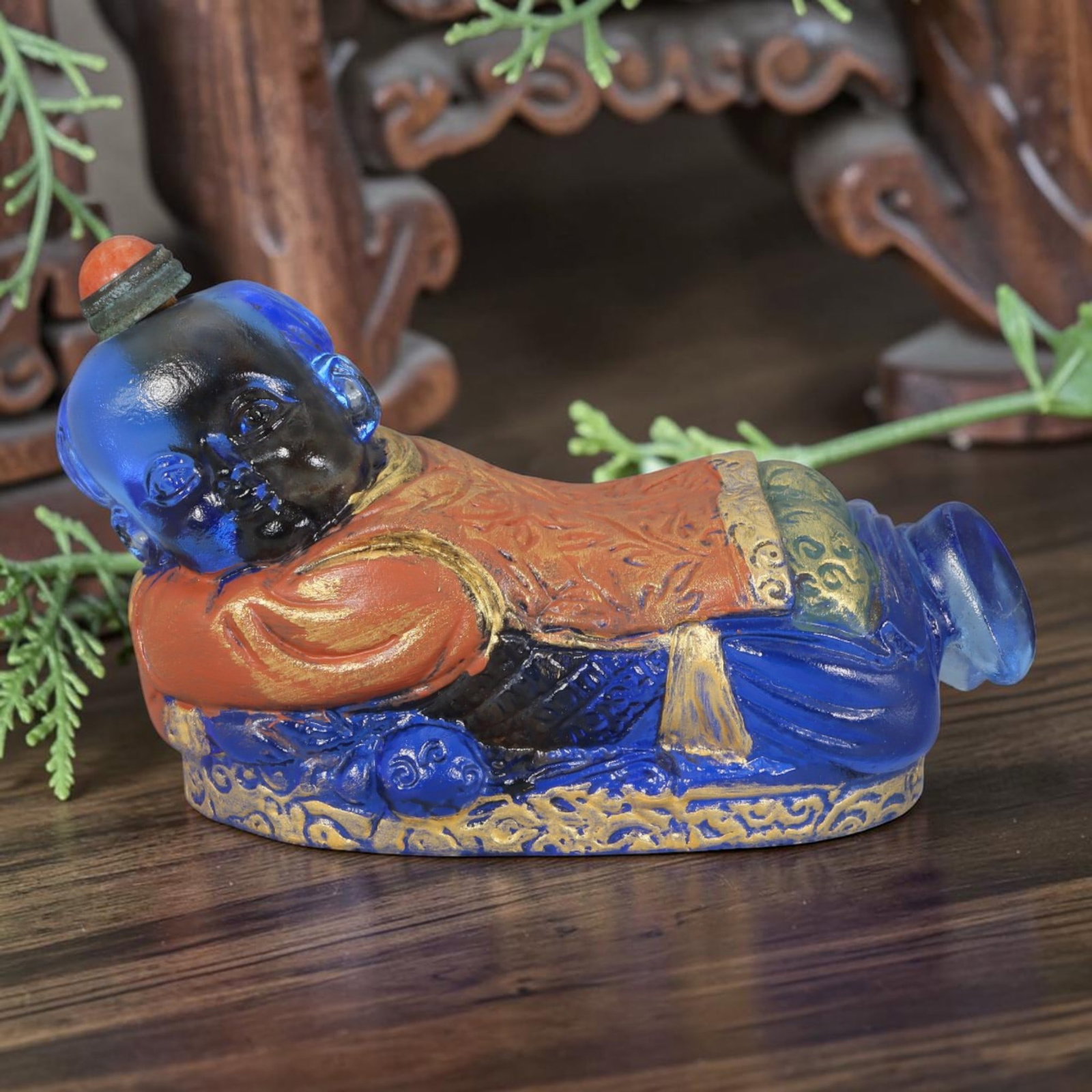 Vintage Chinese Liuli Glass Snuff Bottle - Reclining Sleeping Child, 46AS: This snuff bottle is moulded from translucent deep blue liuli glass, modelled as a reclining sleeping child figure. The robe features raised relief patterns finished with gilded and multi-coloured ena