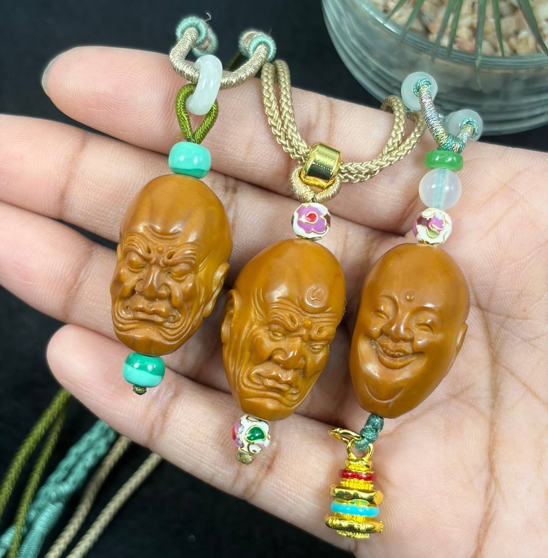 Lot of 3 Hand Carved Olive Nut Arhat Pendant Rope Necklaces, 15AS: Complete set of 3 wearable woven cord pendant necklaces, each featuring meticulously hand-carved natural olive nut focal beads: two solemn arhat luohan heads and one cheerful laughing Buddha head with