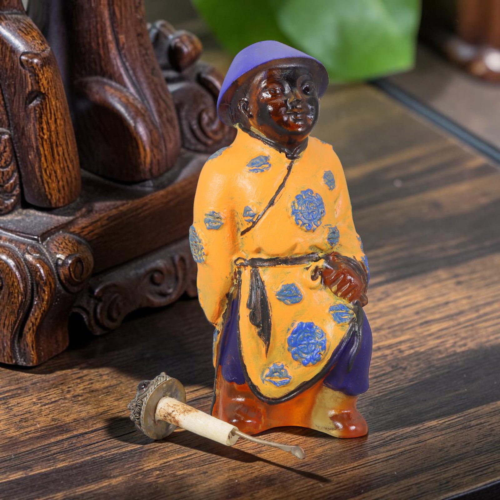Vintage Chinese Liuli Glass Snuff Bottle - Standing Robed Attendant, 51AS: This snuff bottle is moulded from translucent amber liuli glass and formed as a standing attendant figure. The traditional robe is decorated with hand-painted blue floral roundels against an orange gr