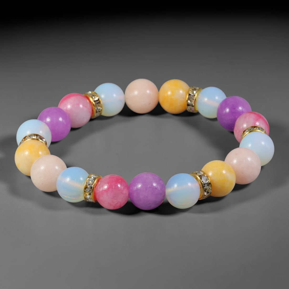 Natural Mixed Stone Beaded Bracelet - Polished Round Bead Strand, 59FA: This elastic stretch bracelet is made of uniformly spherical polished natural mineral beads separated by gold-toned metal spacers set with clear crystalline accents. The stone material displays varied