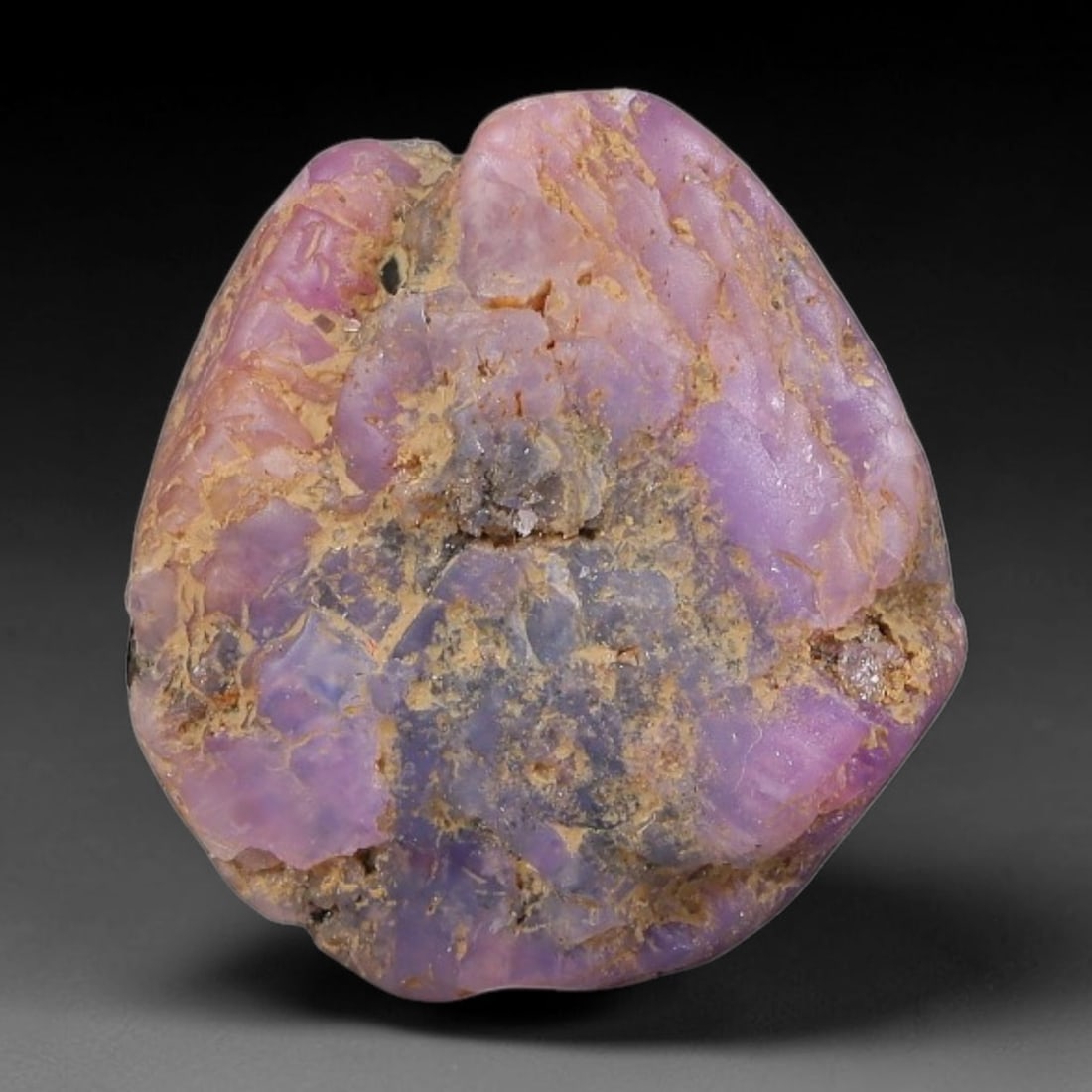 19.47ct Natural Unheated Sri Lankan Purplish Blue Sapphire Rough, 77FC: This natural corundum rough is an unheated purplish blue sapphire sourced from Sri Lankan alluvial gem deposits, featuring an irregular natural native form with residual pale yellow-brown mineral matr