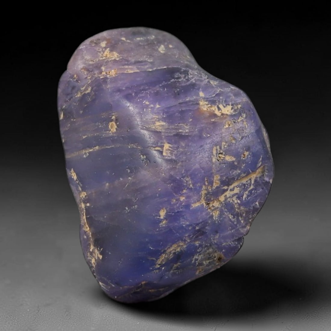30.67ct Natural Unheated Sri Lankan Purplish Blue Sapphire Rough, 95FC: This natural corundum rough is an unheated purplish blue sapphire sourced from Sri Lankan alluvial gem deposits, featuring an irregular natural native form with residual pale yellow-brown mineral matr
