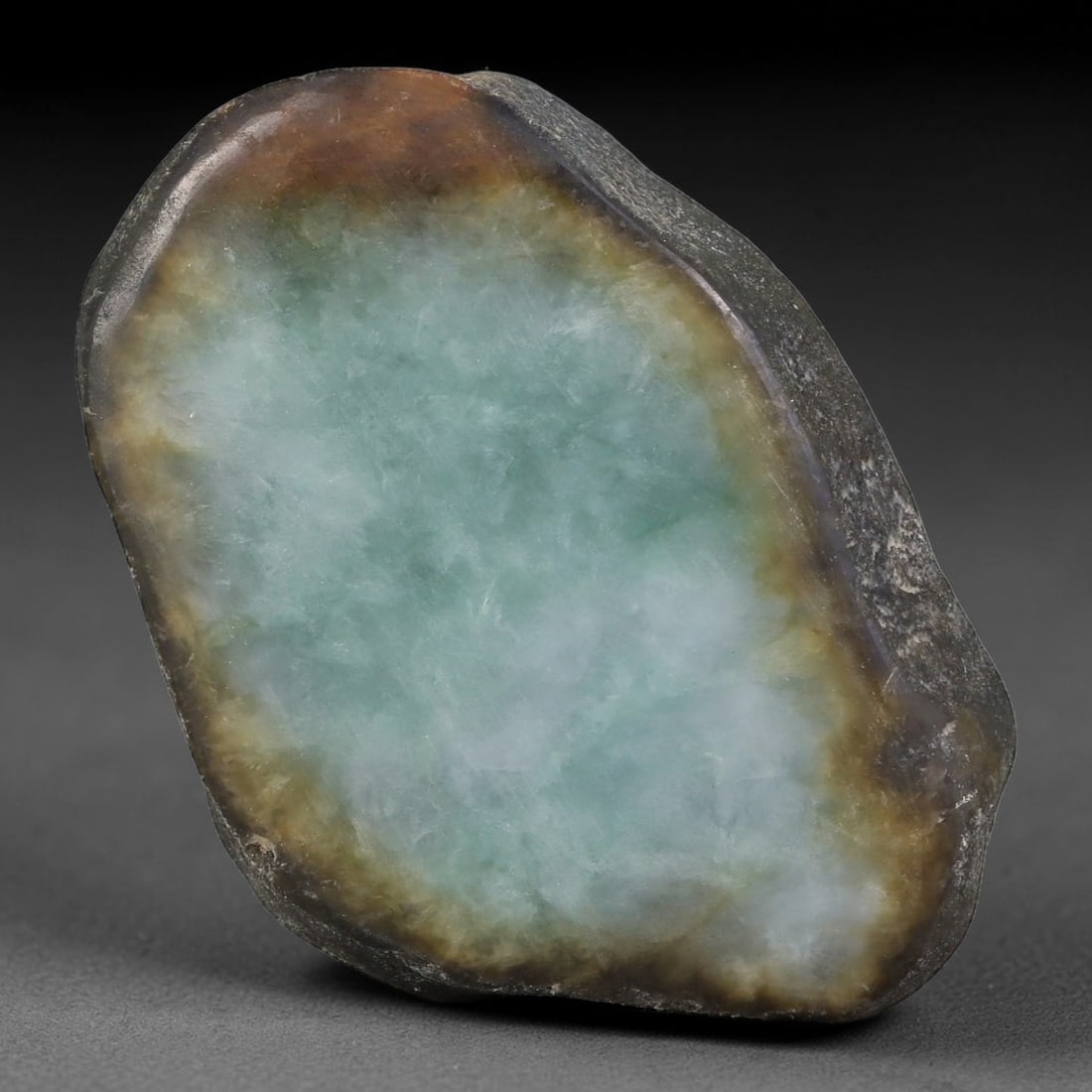 355ct Natural Type A Burmese Jadeite Jade Sliced Rough, 94FA: This specimen is a sliced rough block of natural Type A Burmese jadeite jade. The interior displays natural colour zoning with visible mineral veining and crystalline patterns typical of unprocessed j