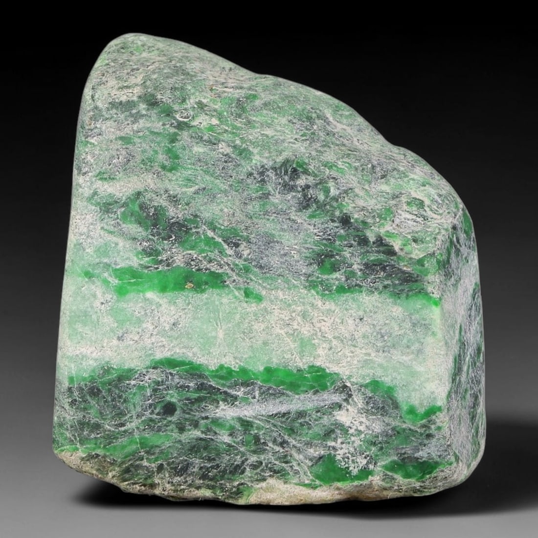 295ct Natural Type A Burmese Jadeite Jade Sliced Rough, 53FB: This specimen is a sliced rough block of natural Type A Burmese jadeite jade. The interior displays natural colour zoning with visible mineral veining and crystalline patterns typical of unprocessed j