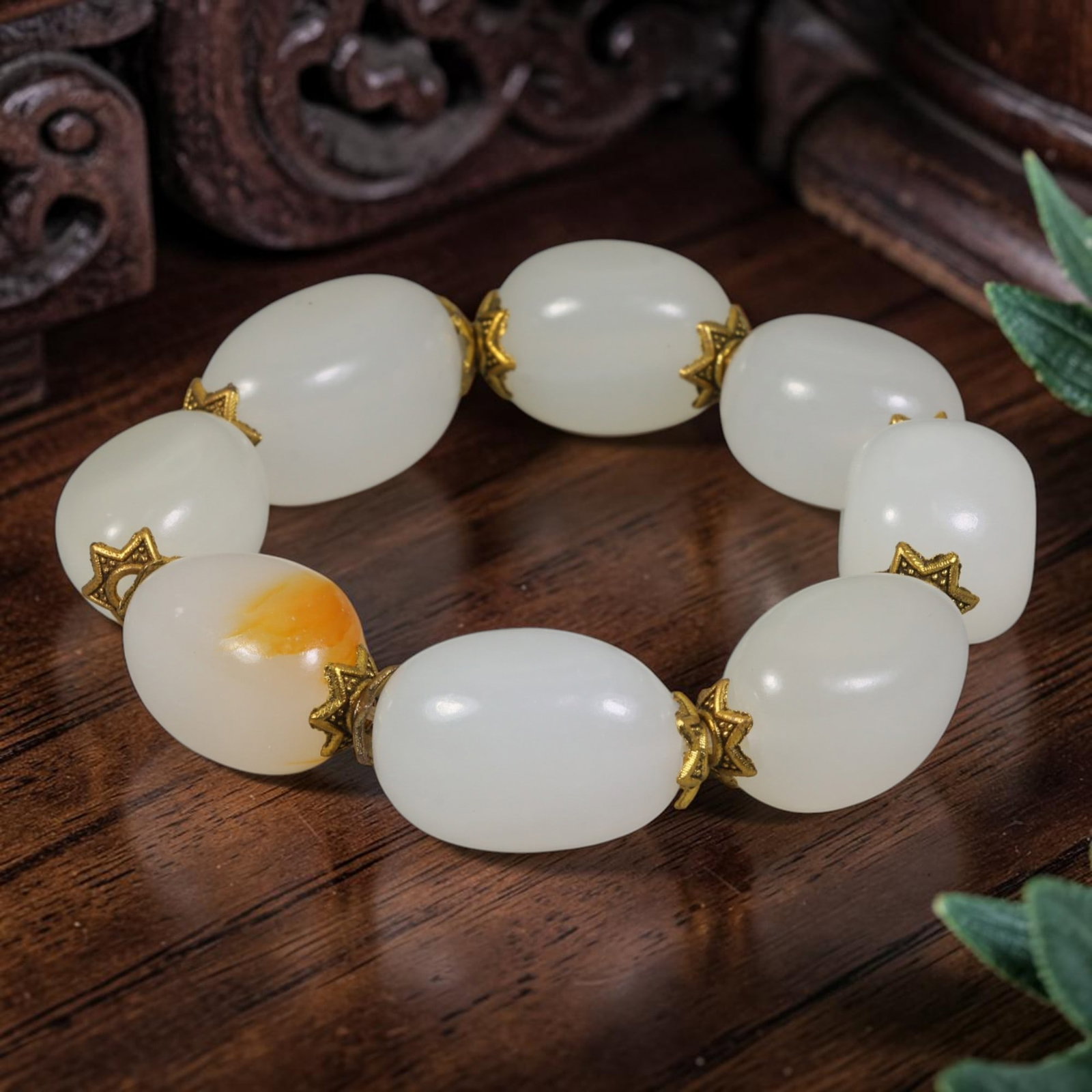 Natural Chinese White Jade Beaded Bracelet - Oval Jade Gilded Spacer Strand, 5AP: Hand-strung bracelet featuring polished oval natural Chinese white jade beads measuring 15mm each, one bead showcasing distinct natural warm amber russet skin inclusion as an inherent stone feature. O