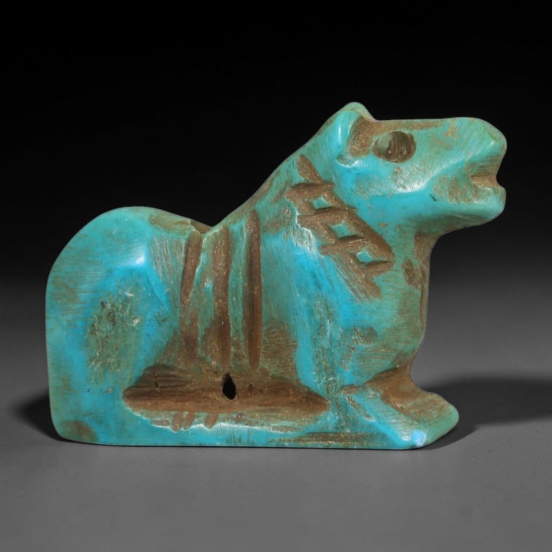 Antique Coptic Egyptian Style Turquoise Stone Feline Zoomorphic Amulet, 86AA: Hand-carved zoomorphic talisman made of natural turquoise stone in antique Coptic Egyptian recumbent feline design, measuring 1.7cm x 1.1cm. The miniature carving depicts a stylized resting cat with i