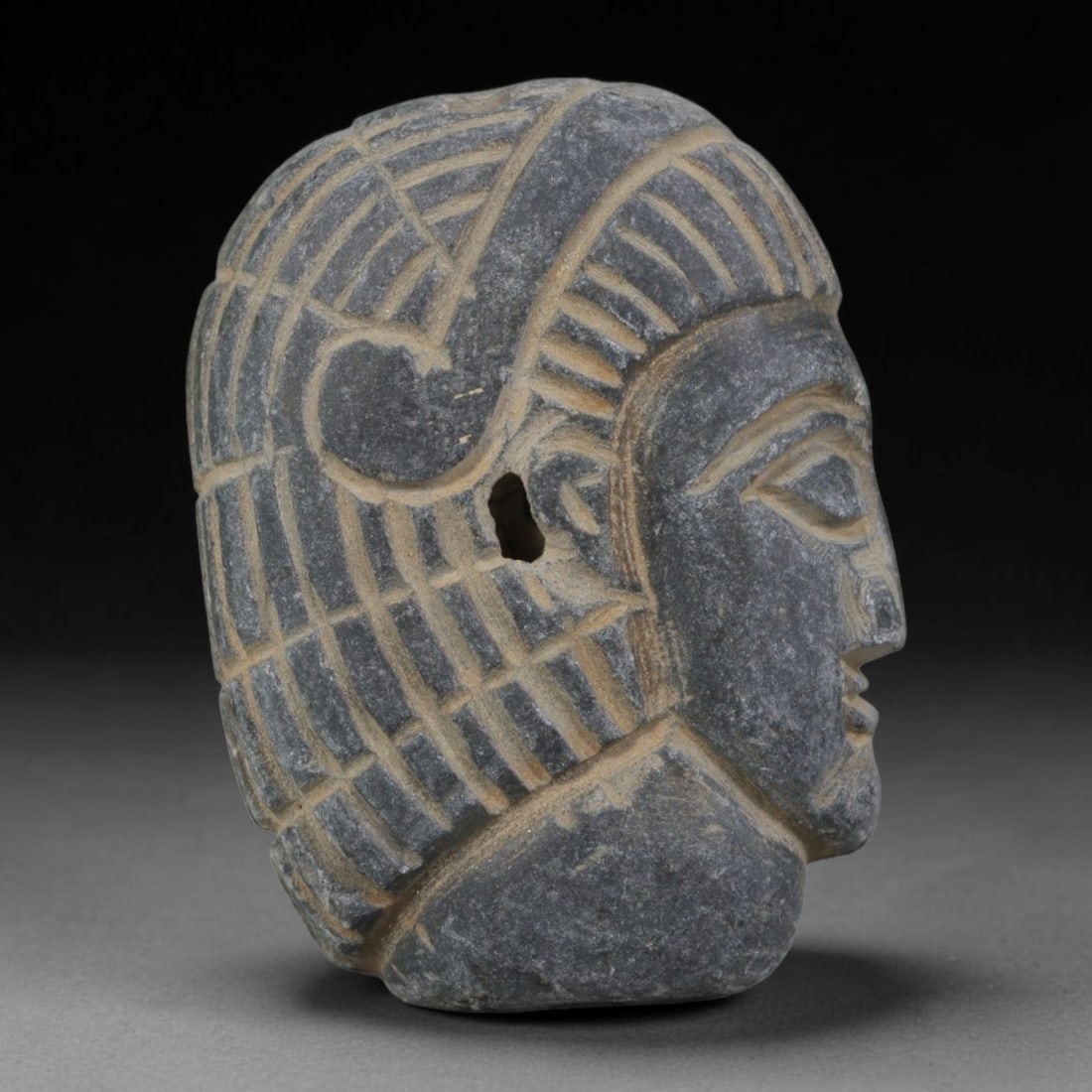Antique Egyptian Schist Intaglio with Profile Head Carving, 35AA: Hand-carved antique Egyptian amulet tablet crafted from dark grey schist stone, measuring 3.5cm x 2.5cm. The front face features a finely detailed profile human head with incised stylized hair rendere