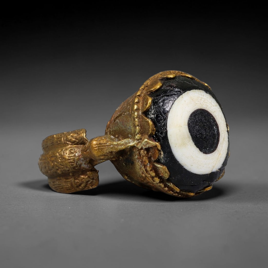 Antique Qajar Dynasty Copper Alloy Ring Set With Banded Glass Bead Cabochon, 60AC: Historic wearable signet ring crafted from textured copper alloy metal, sized to US ring size 8, originating from Qajar Persian artistic and adornment traditions of late medieval Iran. Copper alloy wa