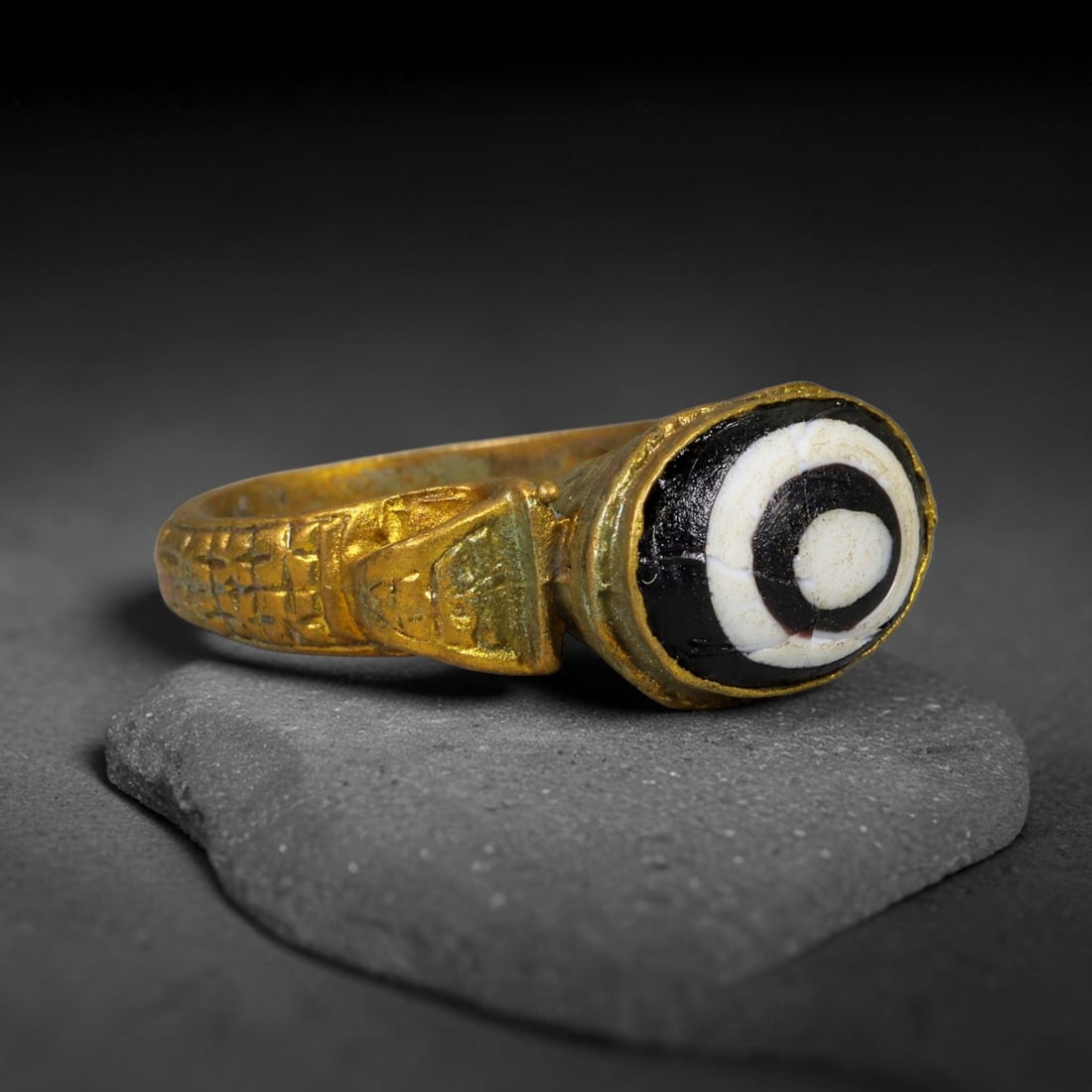 Antique Qajar Dynasty Copper Alloy Ring Set With Banded Glass Bead Cabochon, 55AC: Historic wearable signet ring crafted from textured copper alloy metal, sized to US ring size 8.5, originating from Qajar Persian artistic and adornment traditions of late medieval Iran. Copper alloy 