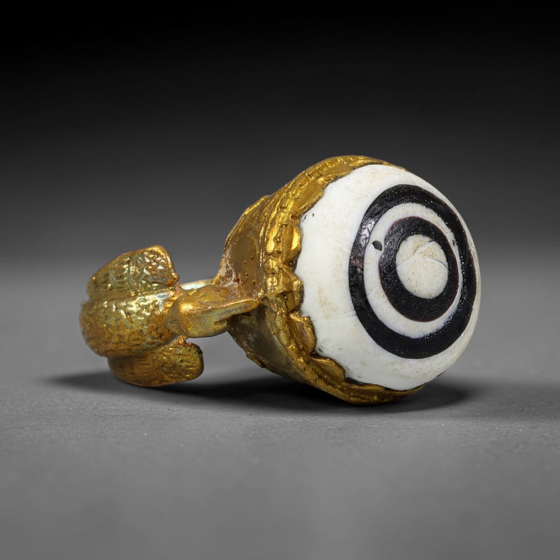 Antique Qajar Dynasty Copper Alloy Ring Set With Banded Glass Bead Cabochon, 61AC: Historic wearable signet ring crafted from textured copper alloy metal, sized to US ring size 8.5, originating from Qajar Persian artistic and adornment traditions of late medieval Iran. Copper alloy 