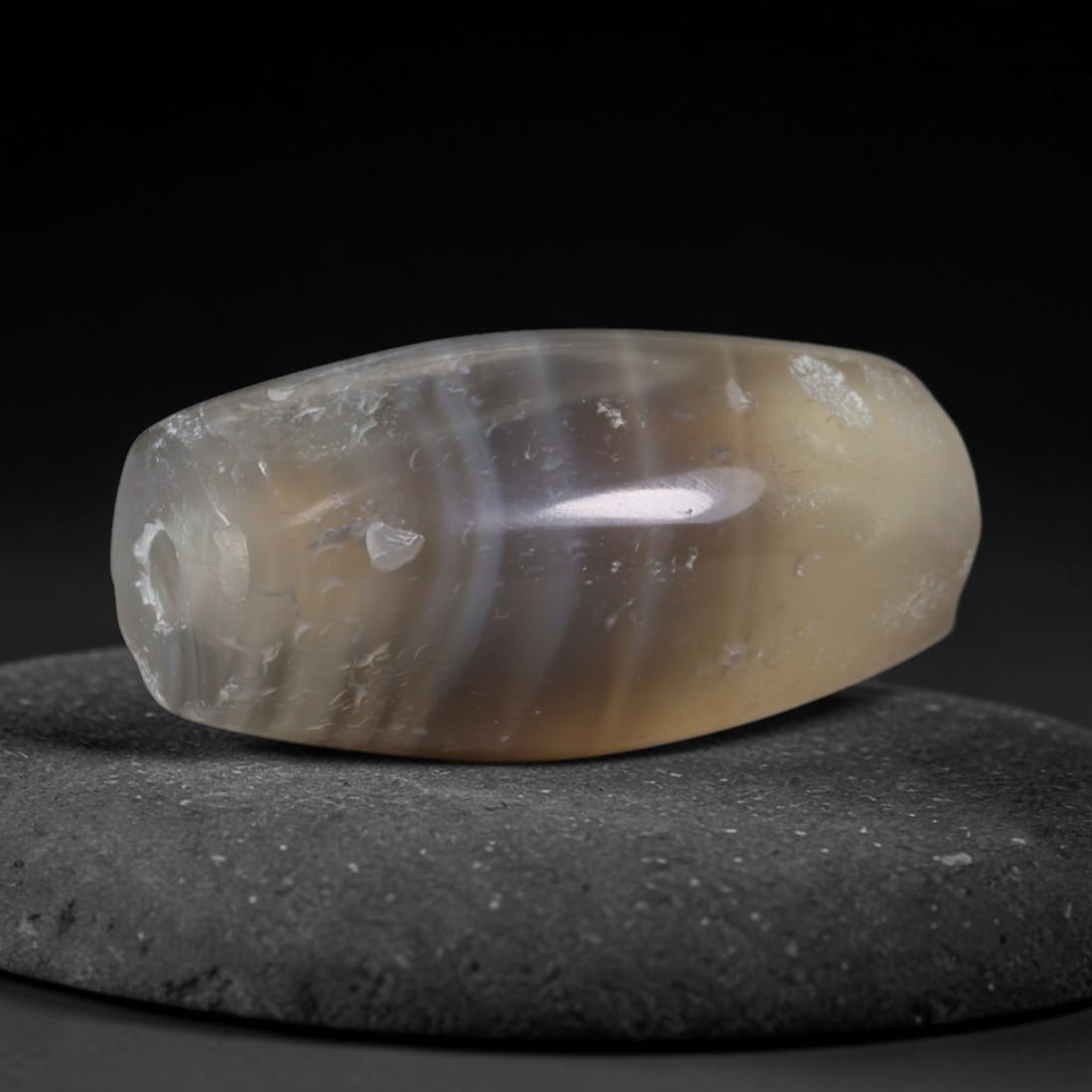 Ancient Achaemenid Persian Empire Banded Agate Barrel Bead (550-330 BCE), 29AD: This antique banded agate barrel bead originates from the Achaemenid Persian Empire, a vast ancient Persian realm renowned for sophisticated agate carving workshops producing royal talismans, burial j