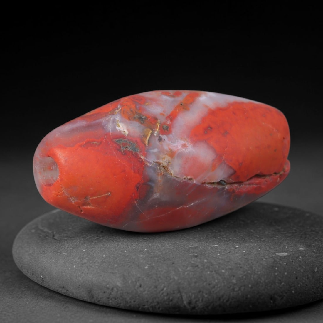 Ancient Shang Dynasty Red Inclusion Agate Barrel Bead (1600-1046 BCE), 91AD: This antique red agate barrel bead originates from China's Shang Dynasty, one of ancient China's earliest bronze-age civilizations celebrated for revered stone carving traditions that produced ritual 