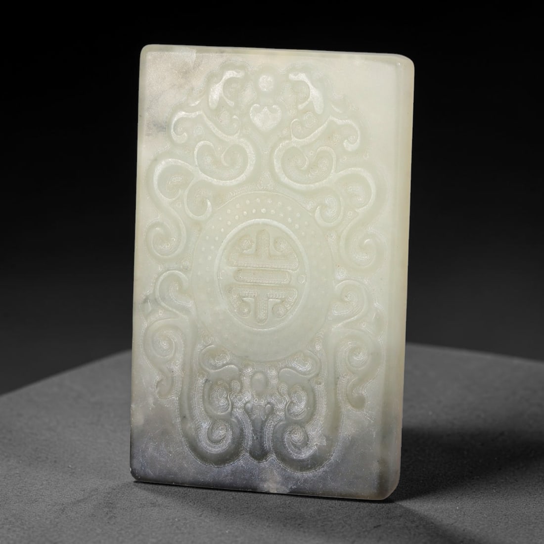 Chinese Nephrite Jade Plaque - Longevity Motif Tablet, 8AE: Crafted from natural nephrite jade featuring soft grey mottling throughout the pale celadon stone matrix, this rectangular tablet displays precise relief carving with uniform fine incised linework typ