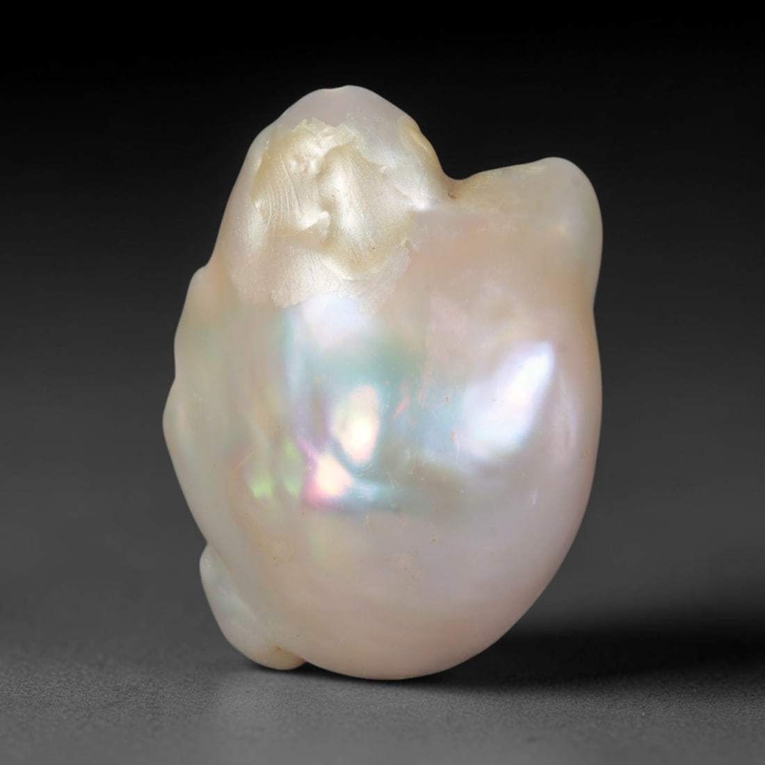 Natural Freshwater Keshi Pearl - Iridescent Baroque Pearl Ornament, 62AE: A natural freshwater keshi pearl with organic asymmetrical baroque shaping, exhibiting soft creamy blush base tones with shifting pastel pink, lavender and pale gold iridescent luster across its smoot