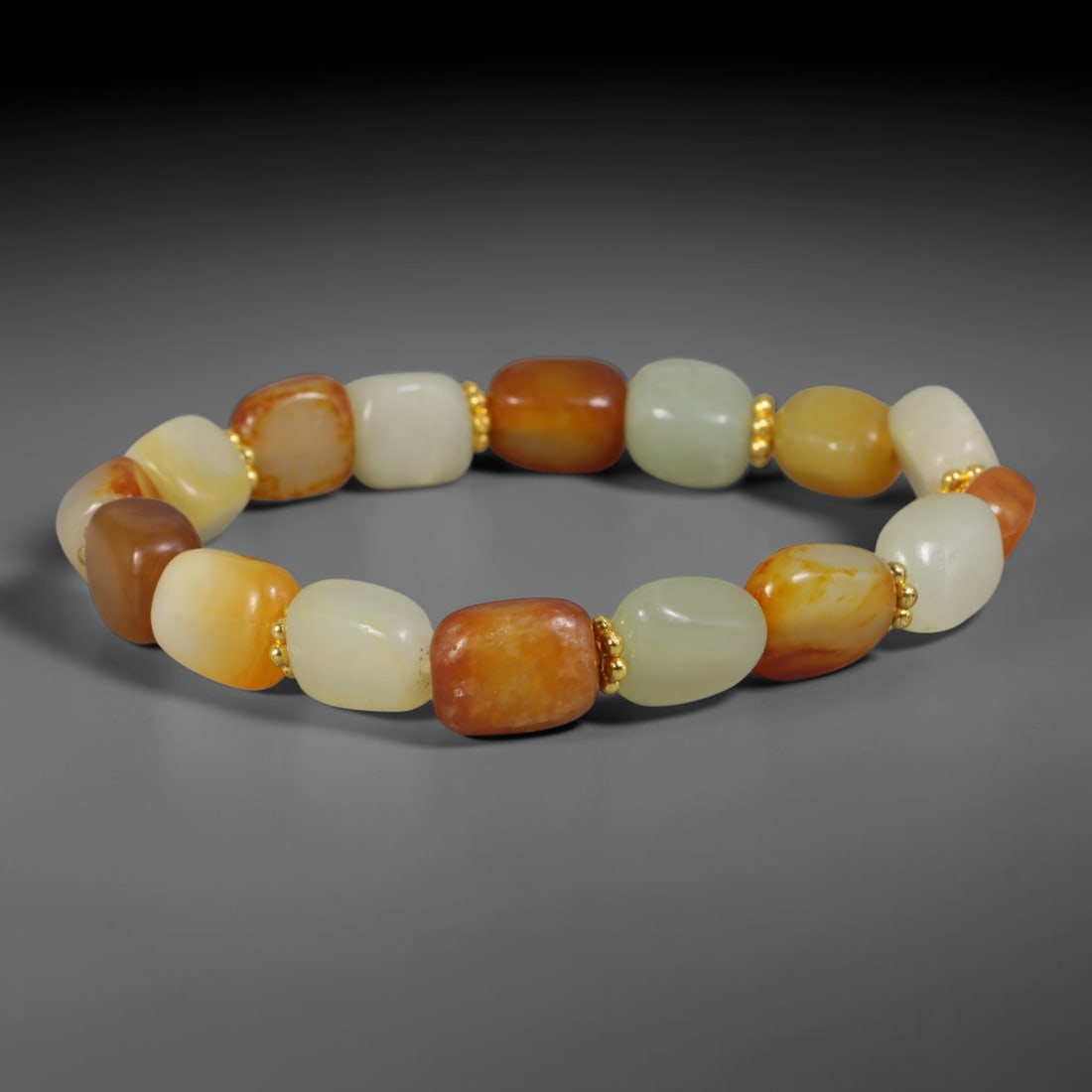 Natural Chinese Xinjiang Hetian Nephrite Jade Pebble Bracelet with Gold Tone Spacers, 70AE: This wearable bracelet is crafted from polished natural Xinjiang Hetian nephrite river pebble beads with soft freeform rectangular pebble shaping, accented by tiny polished gold-toned metallic spacer 