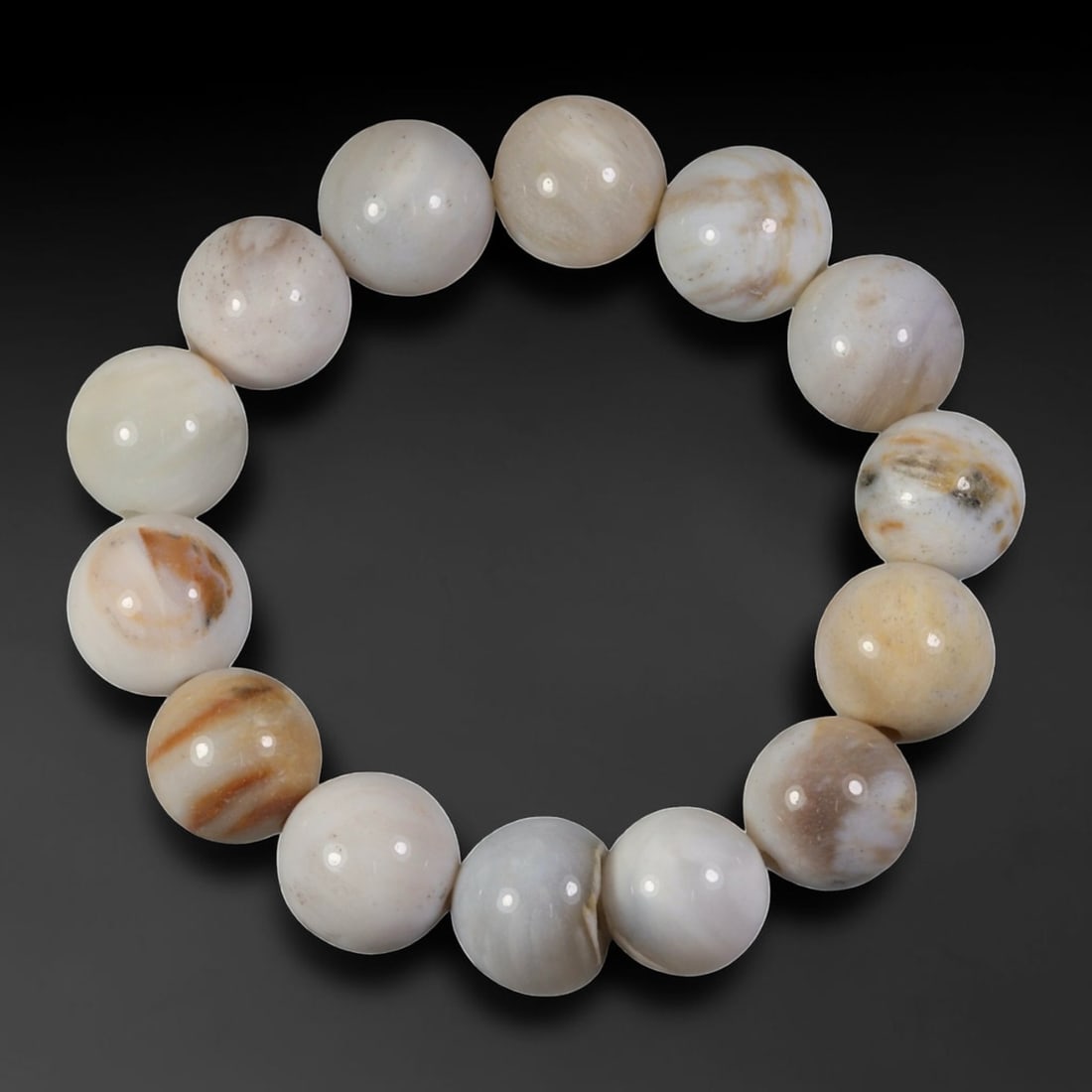 Natural Burmese Fossilized Wood Beaded Bracelet, 2AK: Come take a look at this one-of-a-kind fossilized wood bracelet, a little piece of ancient history you can wear! This bracelet has a comfortable 56mm diameter, strung with smooth, polished round beads