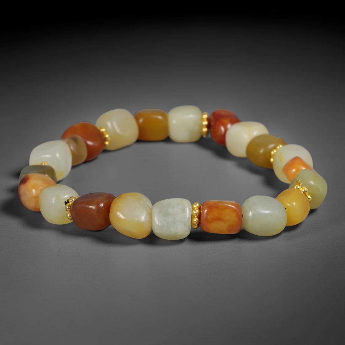 Natural Chinese Xinjiang Hetian Nephrite Jade Pebble Bracelet with Gold Tone Spacers, 72AE: Hand-polished natural Xinjiang Hetian nephrite river pebble beads form this delicate bracelet, separated by small polished gold-toned metallic spacer beads between each stone. The freeform soft pebble