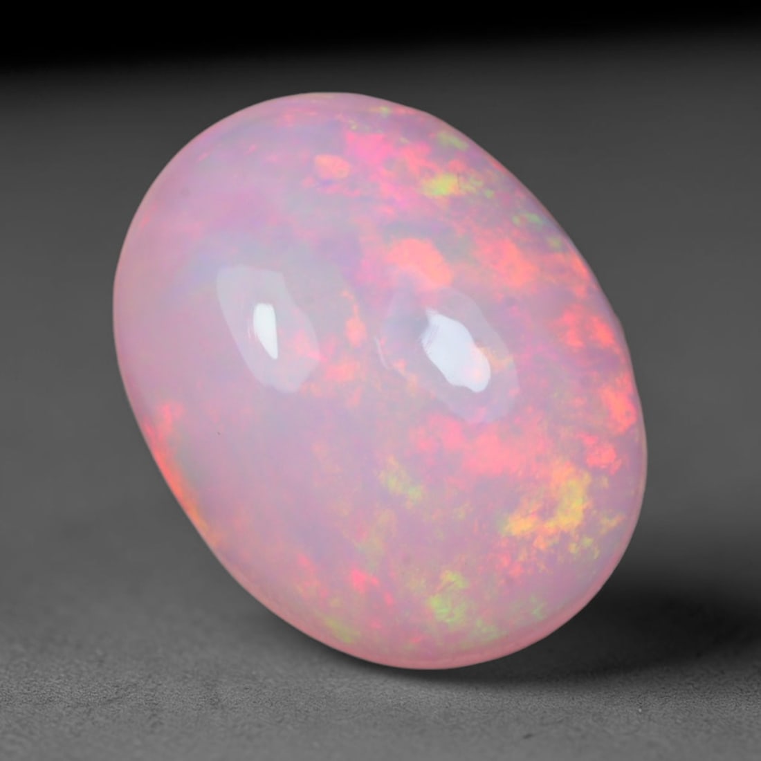 2.20 Carats Natural Ethiopian Welo Pastel Blush Pink Opal Cabochon Loose Gemstone, 53AG: This smoothly polished opal features a soft pale blush pink base scattered with shifting patches of coral red, lime green and warm golden yellow play of color, measured at 11.1x8.7x4.7mm, its gentle r
