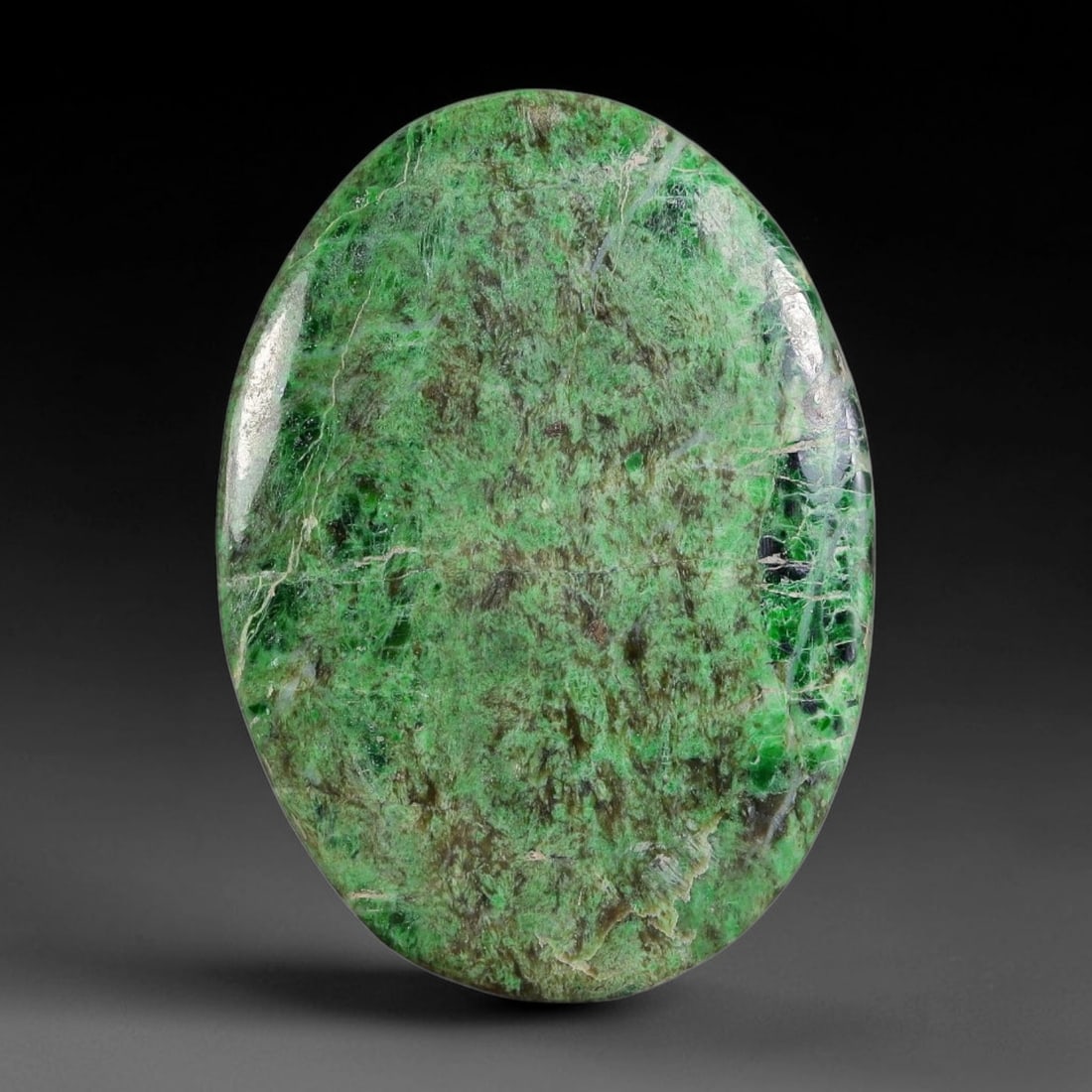 16ct Natural Burmese Type A Moss Green Matrix Veined Jadeite Jade Cabochon, 28FA: This single untreated natural Burmese Type A oval jadeite jade cabochon weighs 16ct with dimensions of 29.6x21.4x3mm. The stone features a dense moss green matrix mixed with earthy brown mineral depos