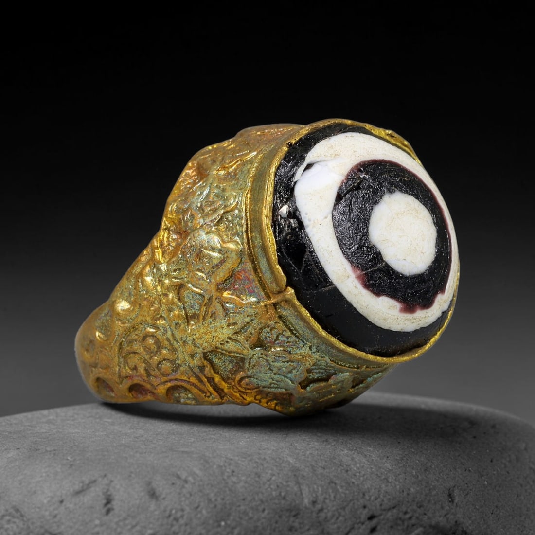 Antique Qajar Dynasty Copper Alloy Ring Set With Banded Glass Bead Cabochon, 65AC: Historic wearable signet ring crafted from textured copper alloy metal, sized to US ring size 8.5, originating from Qajar Persian artistic and adornment traditions of late medieval Iran. Copper alloy 