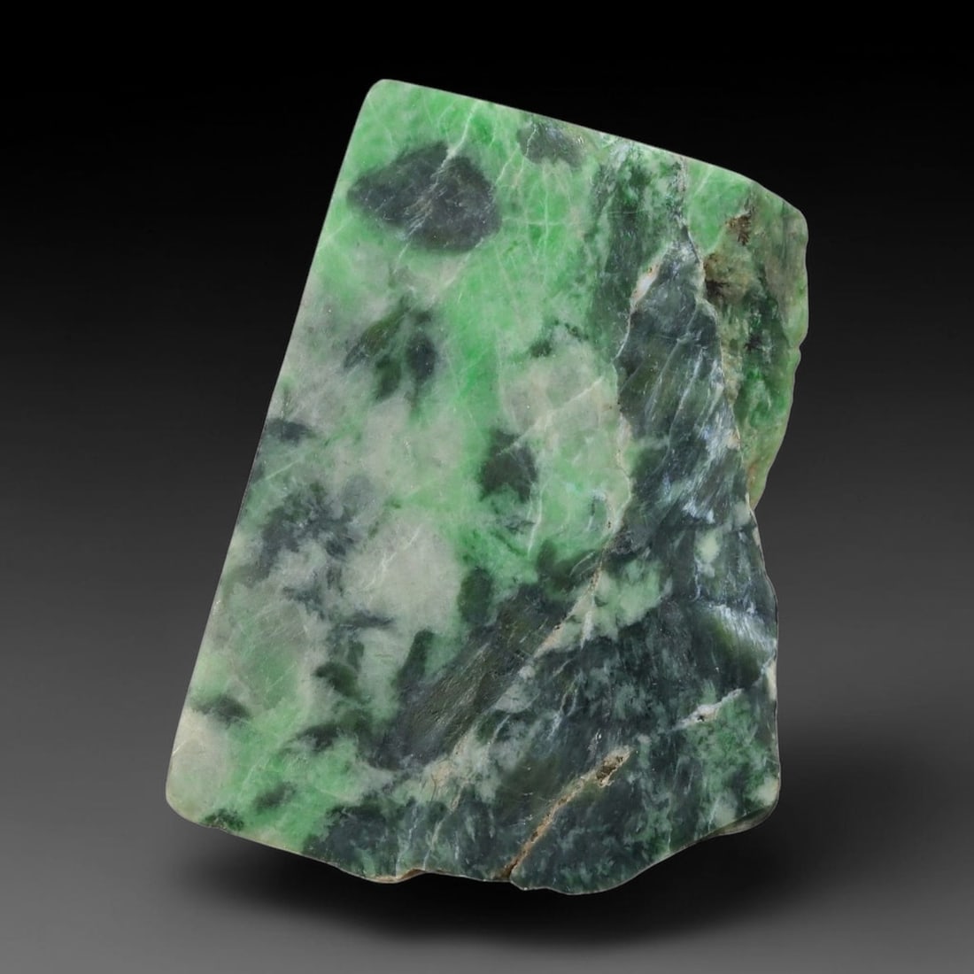 125ct Natural Type A Burmese Jadeite Jade Sliced Rough, 11AZ: This specimen is a sliced rough block of natural Type A Burmese jadeite jade. The interior displays natural colour zoning with visible mineral veining and crystalline patterns typical of unprocessed j