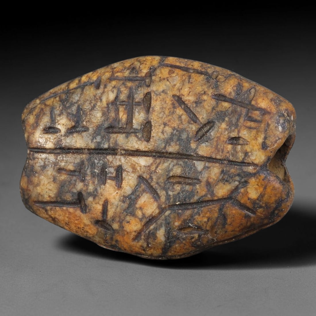 Ancient Medieval Seljuk Persian Carved Stone Talisman Bead (1037-1307 CE), 77AB: This mottled warm-toned stone bead originates from Seljuk Persian Culture, mass-carved protective script talismans worn as portable jewelry amulets across medieval Persian trade networks. Deep incised