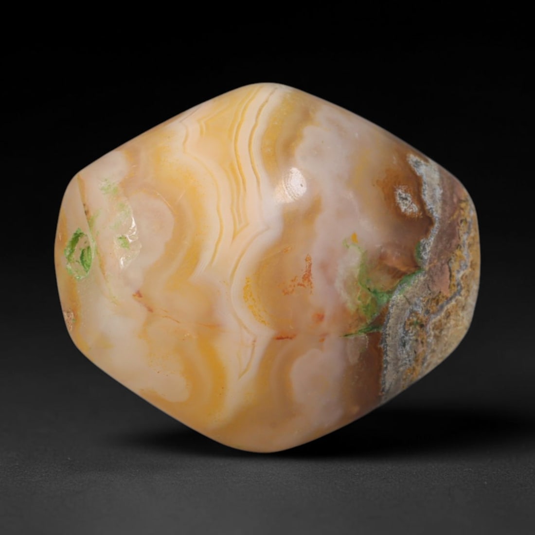 Ancient Sasanian Persian Honey Wavy Banded Agate Faceted Barrel Bead (224-651 CE), 66AD: This substantial warm-toned banded agate barrel bead originates from the Sasanian Persian Empire, a dominant late antique Near Eastern civilization celebrated for elite lapidary workshops producing ta