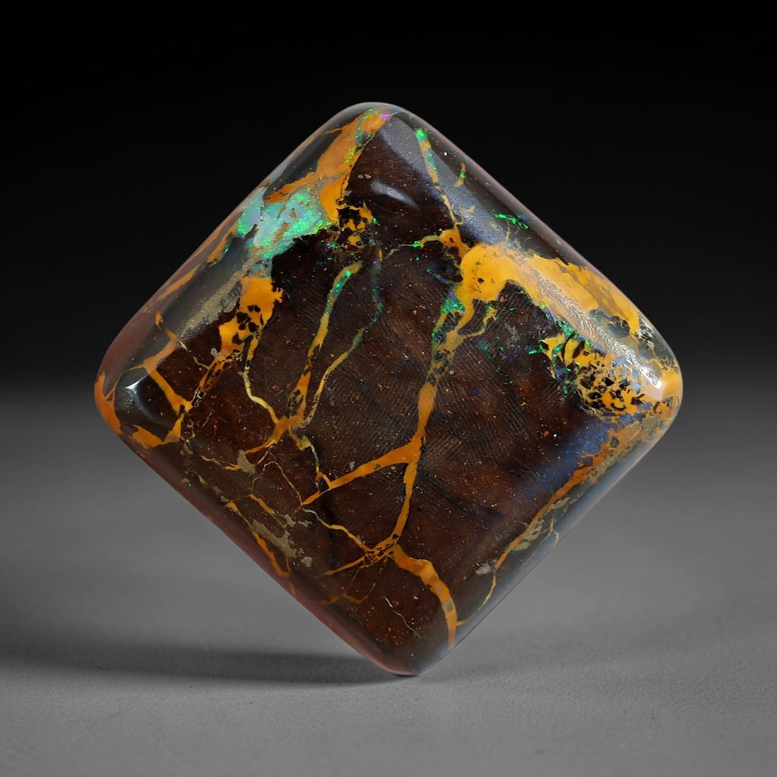 14.88ct Natural Australian Queensland Matrix Boulder Opal Cabochon, 18AV: Hand polished diagonal rounded square cushion cabochon crafted from natural Queensland matrix boulder opal, featuring deep rich brown ironstone host matrix threaded with thick sweeping golden amber op