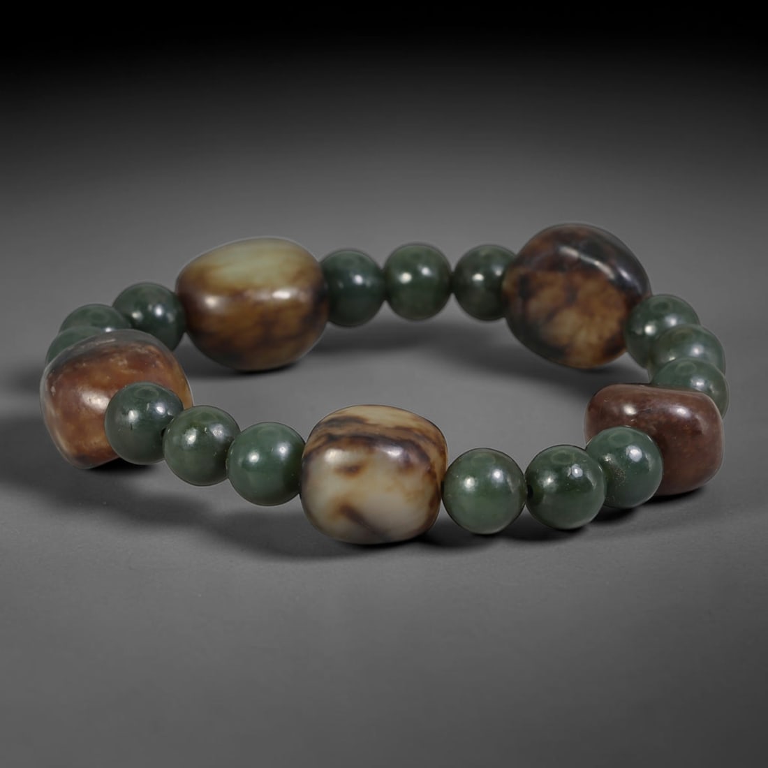 Mixed Natural Chinese Xinjiang Hetian Nephrite Jade Bracelet, 77AE: Hand-strung Hetian nephrite bracelet blending smooth polished dark green spherical nephrite spacer beads and organic freeform Xinjiang river pebble focal stones. The natural pebble nephrite displays v