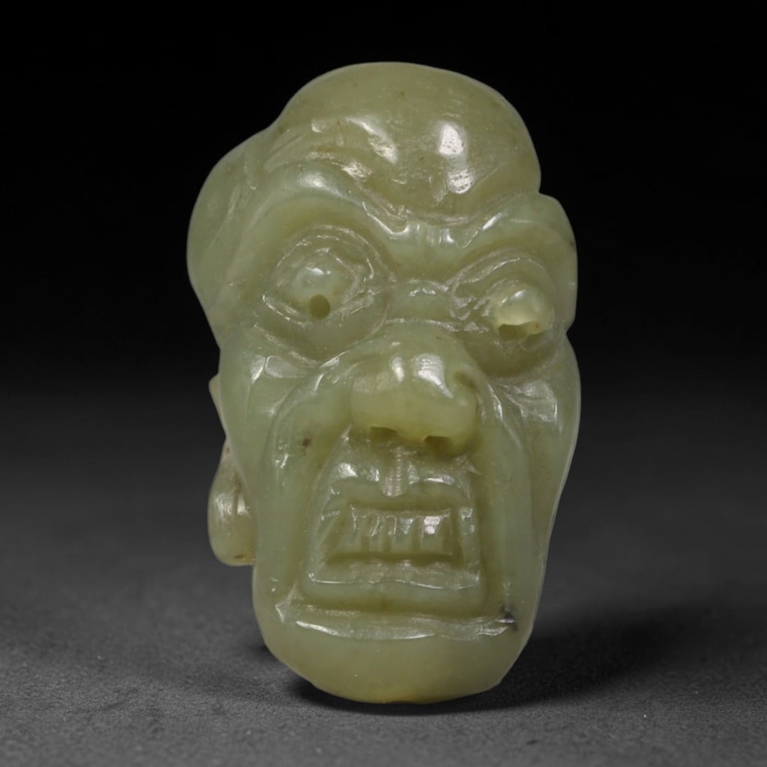 Natural Vintage Chinese Nephrite Jade Pale Yellow Arhat Head Carved Face Bead, 33AP: Hand-carved vintage Chinese strung bead made from natural vintage Chinese nephrite jade, sized 3cm x 2cm. This barrel-form bead is fully sculpted into a striking Buddhist Arhat facial bust, featuring 