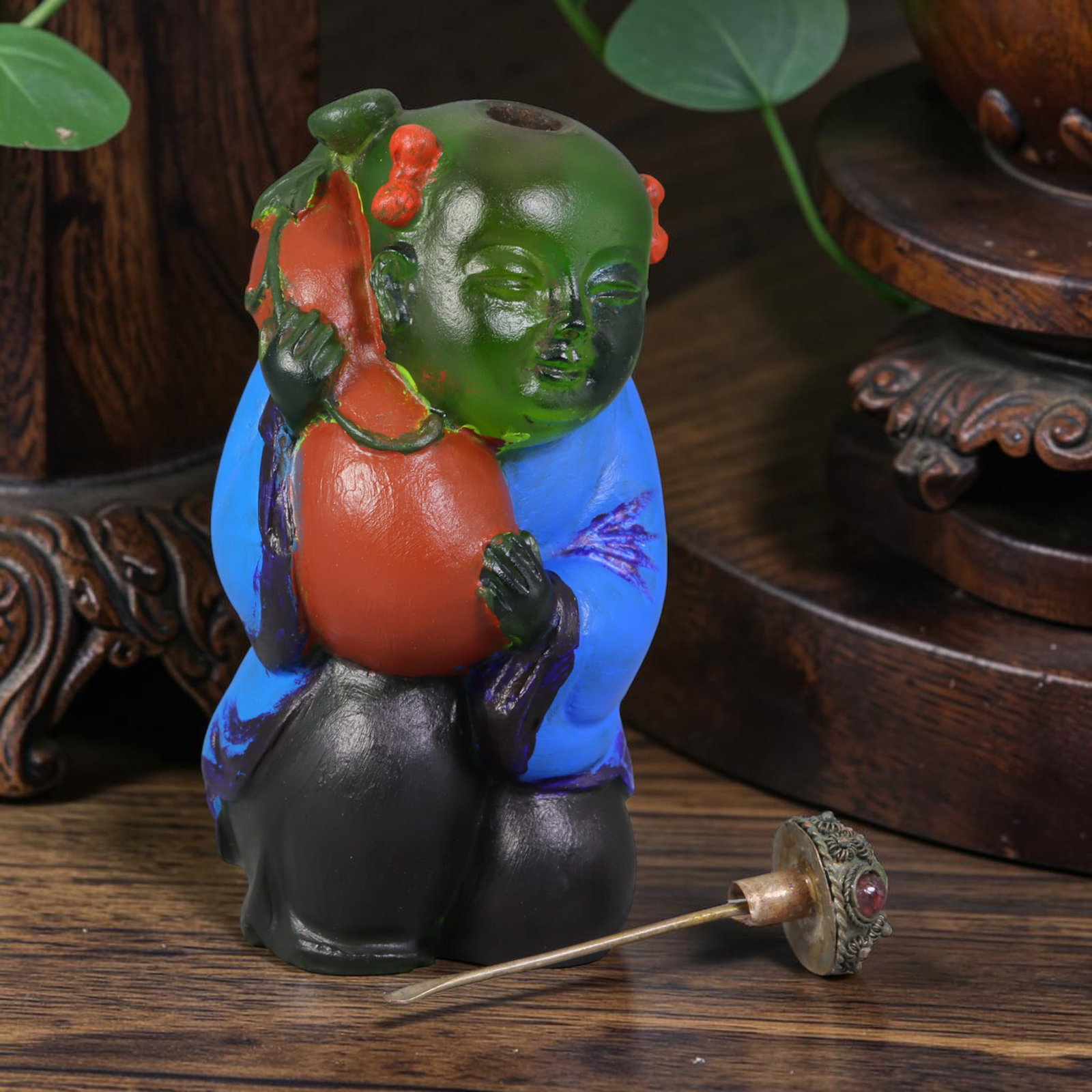 Vintage Chinese Liuli Glass Snuff Bottle - Boy Holding Gourd, 38AS: This snuff bottle is moulded from translucent green liuli glass, shaped as a young boy clutching a red gourd symbolizing good fortune. The garment is finished with hand-painted enamel in rich blue and