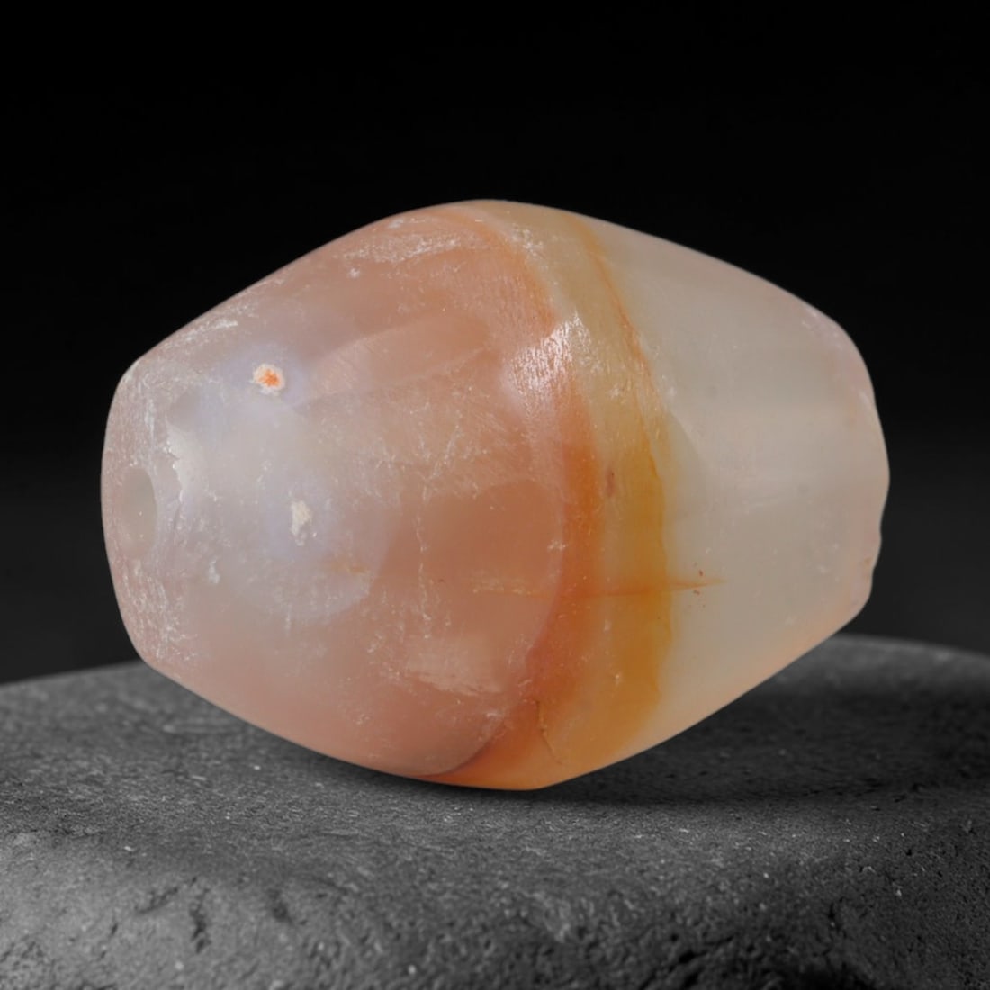Ancient Song Dynasty Peach Amber Banded Agate Faceted Barrel Bead (960-1279 CE), 94AD: This antique soft-toned banded agate barrel bead originates from China's Song Dynasty, an era of refined domestic lapidary arts focused on subtle natural stone ornamentation for literati and noble per