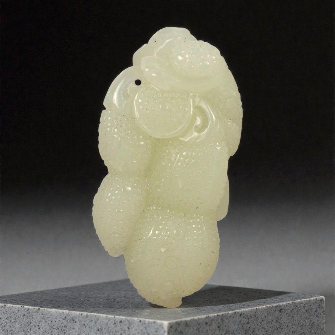 A Chinese Jade Beast and Fruit Carving, 20th Century, 78FA: Carved from pale green to light yellow jade with areas of translucency and scattered natural inclusions, the object represents a stylized beast crouched upon a fruiting form. The creature is rendered 