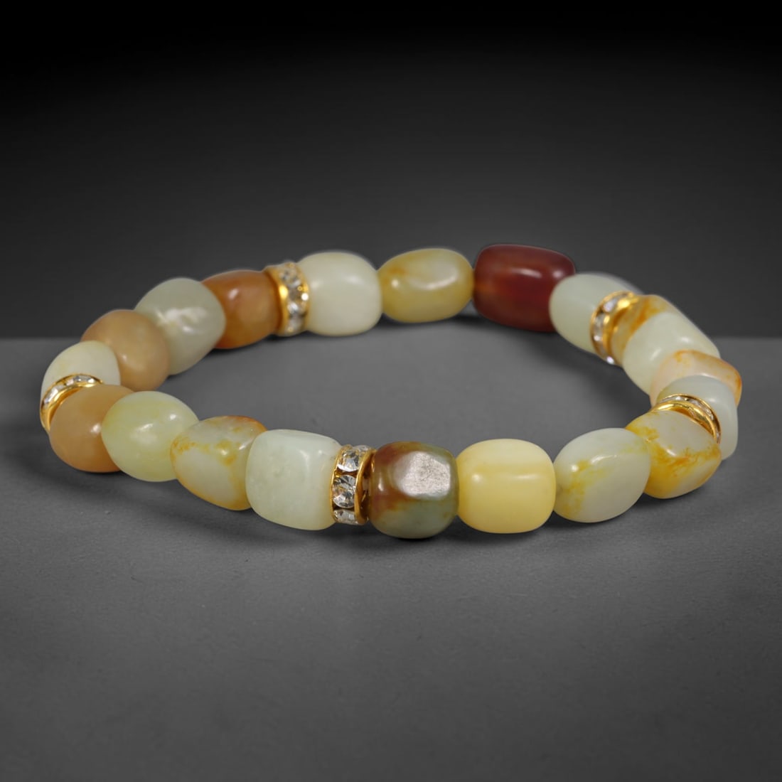 Natural Chinese Xinjiang Hetian Nephrite Jade Pebble Bracelet with Crystal Gold Tone Spacers, 67AE: This elegant bracelet is constructed from hand-polished natural Xinjiang Hetian nephrite river pebble beads with soft freeform barrel shaping, accented by gold-toned metallic spacer rings encrusted wi